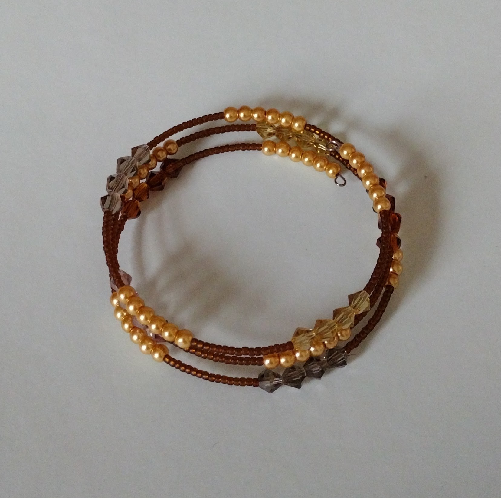 Rootbeer memory-wire bangle showing its three coiled rows