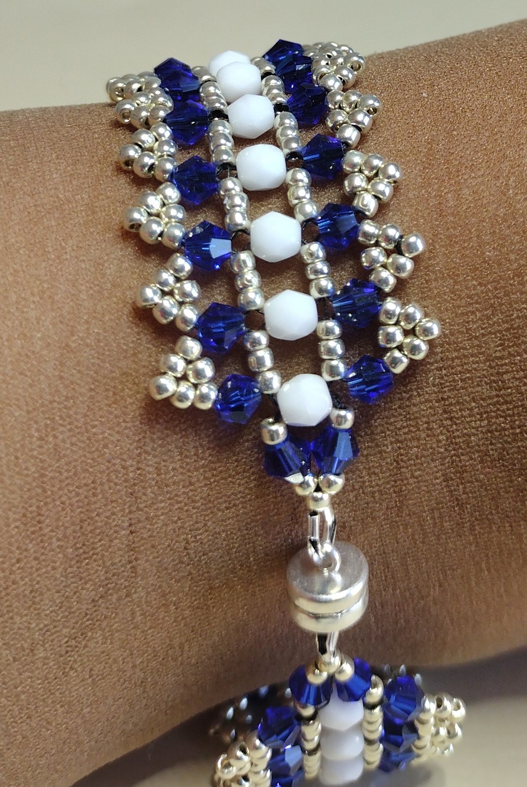 Close view of the sapphire-blue and white crystal bracelet on a wrist