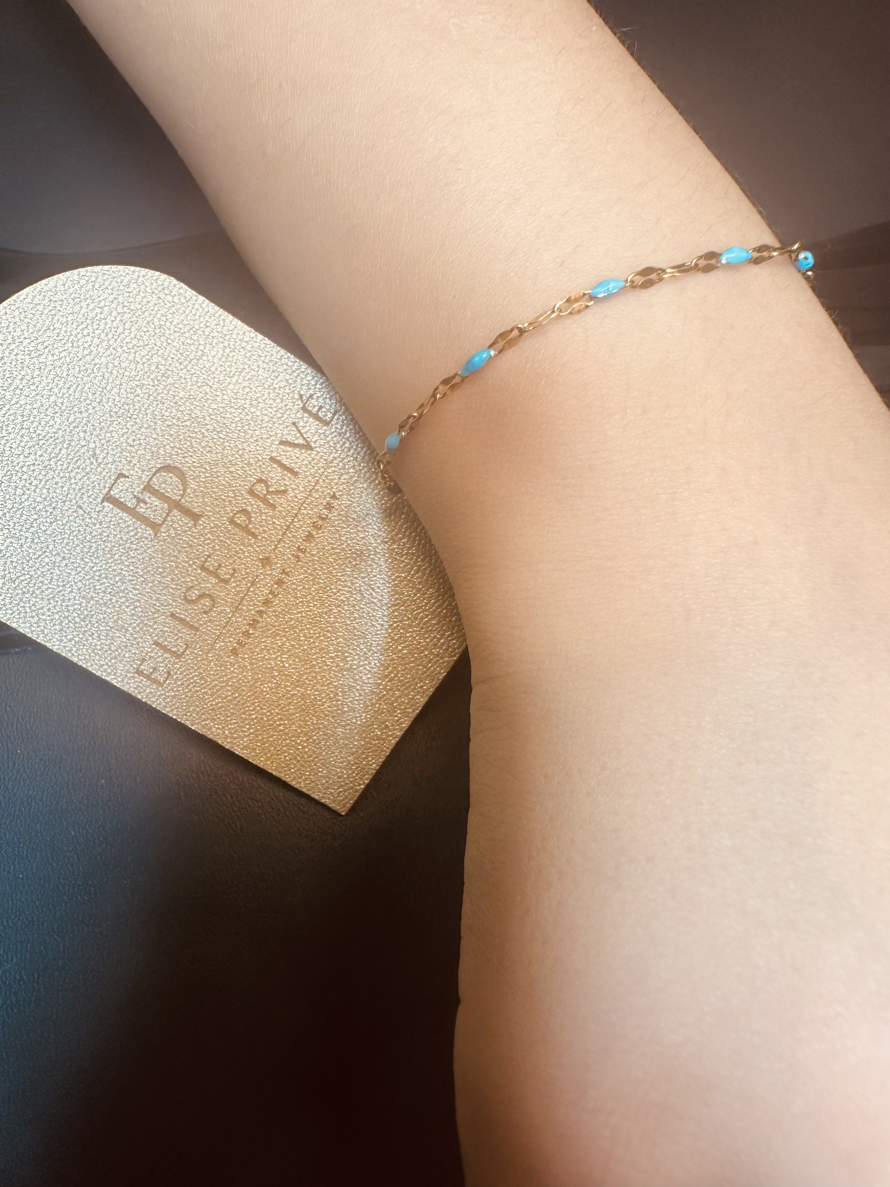 Delicate permanent jewelry on a wrist