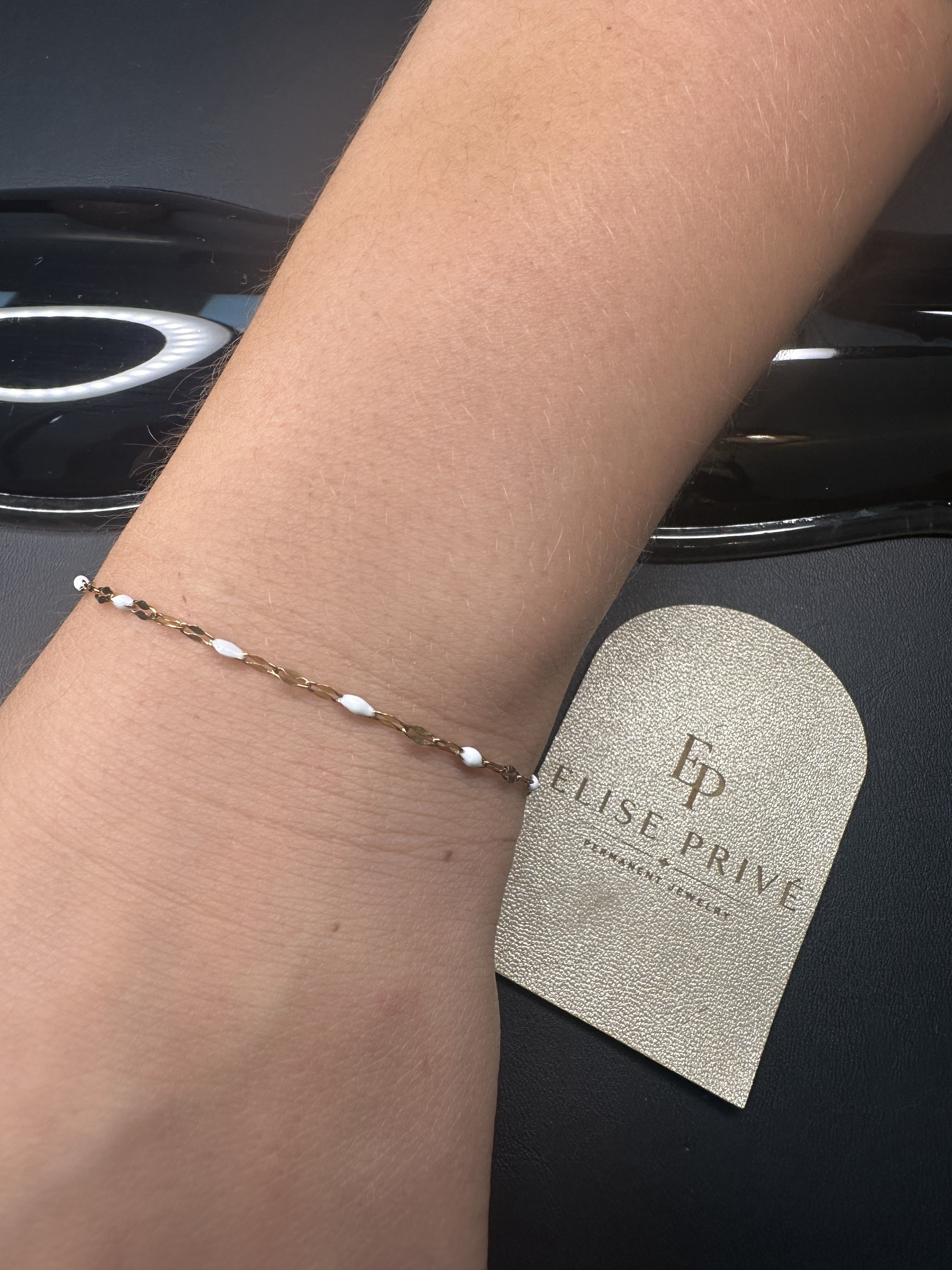Fine permanent bracelet on a wrist