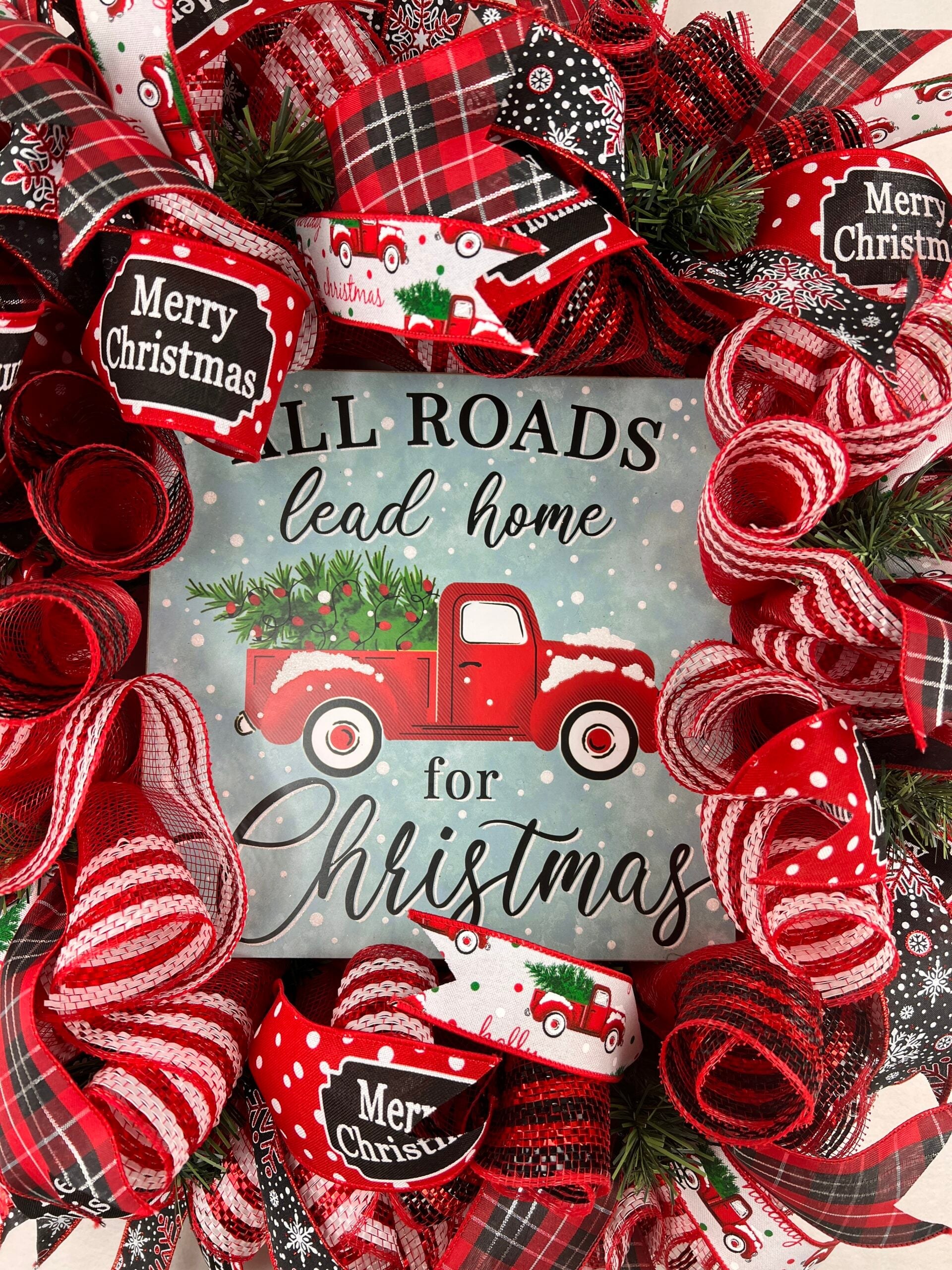 Christmas deco mesh wreath with repeated red plaid, snowflake, and message ribbons