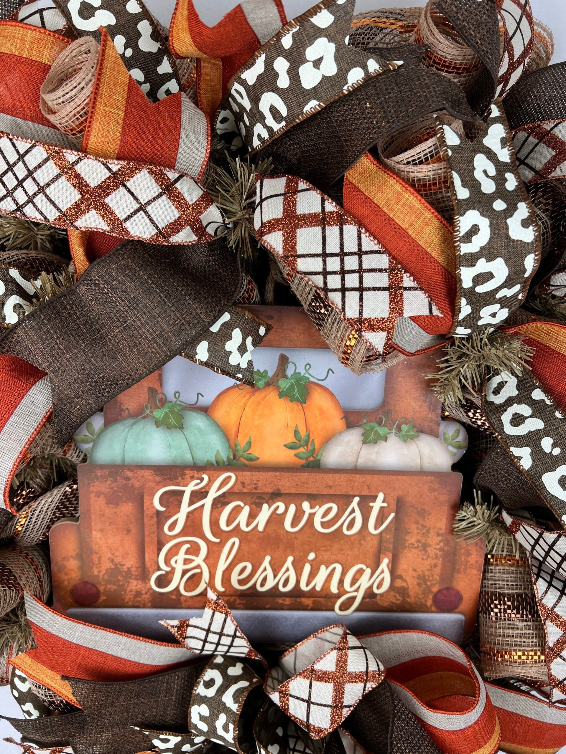 Layered handmade harvest wreath with pumpkin and ribbon details