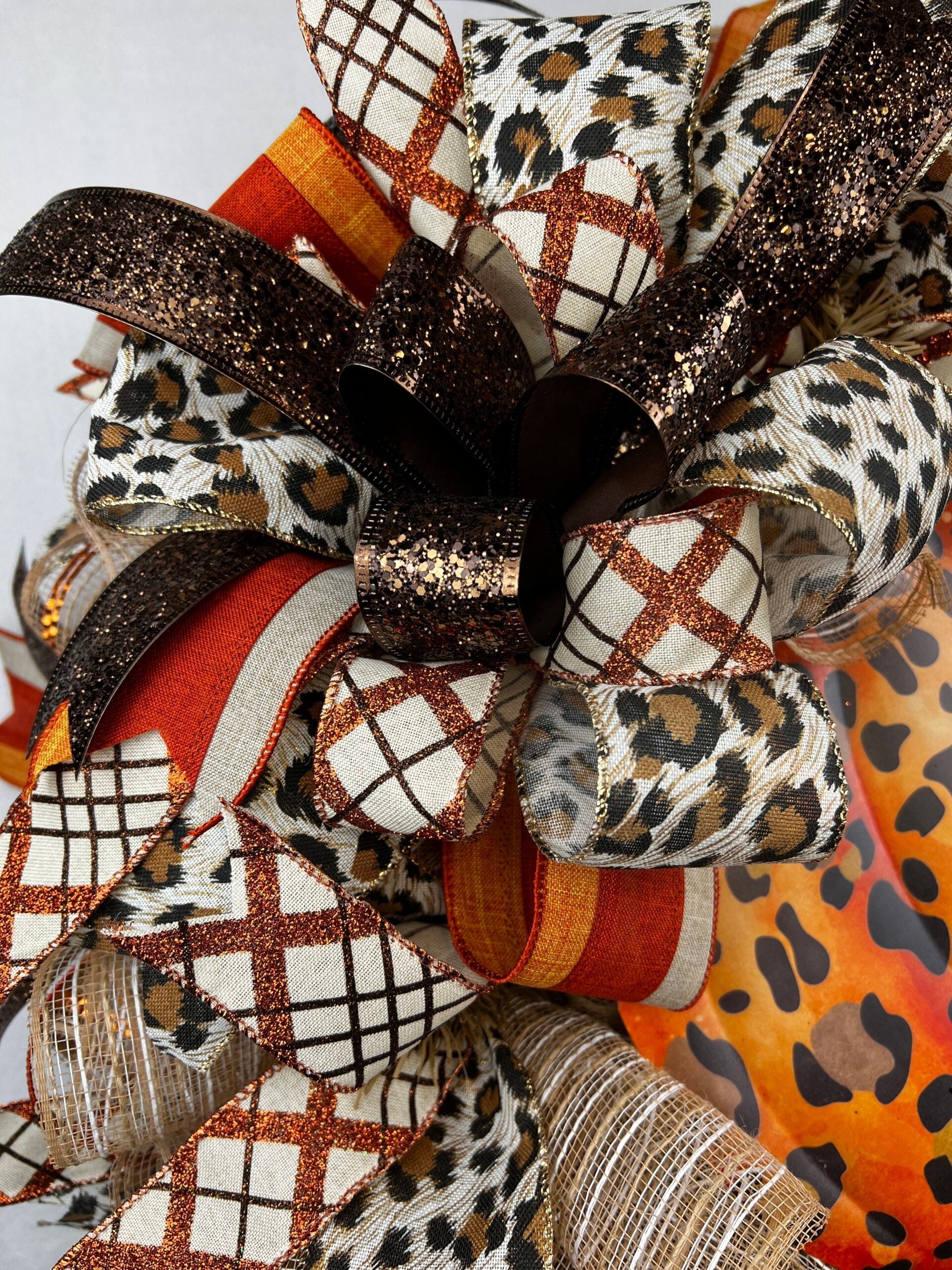 Fall wreath with layered orange and patterned ribbon bow