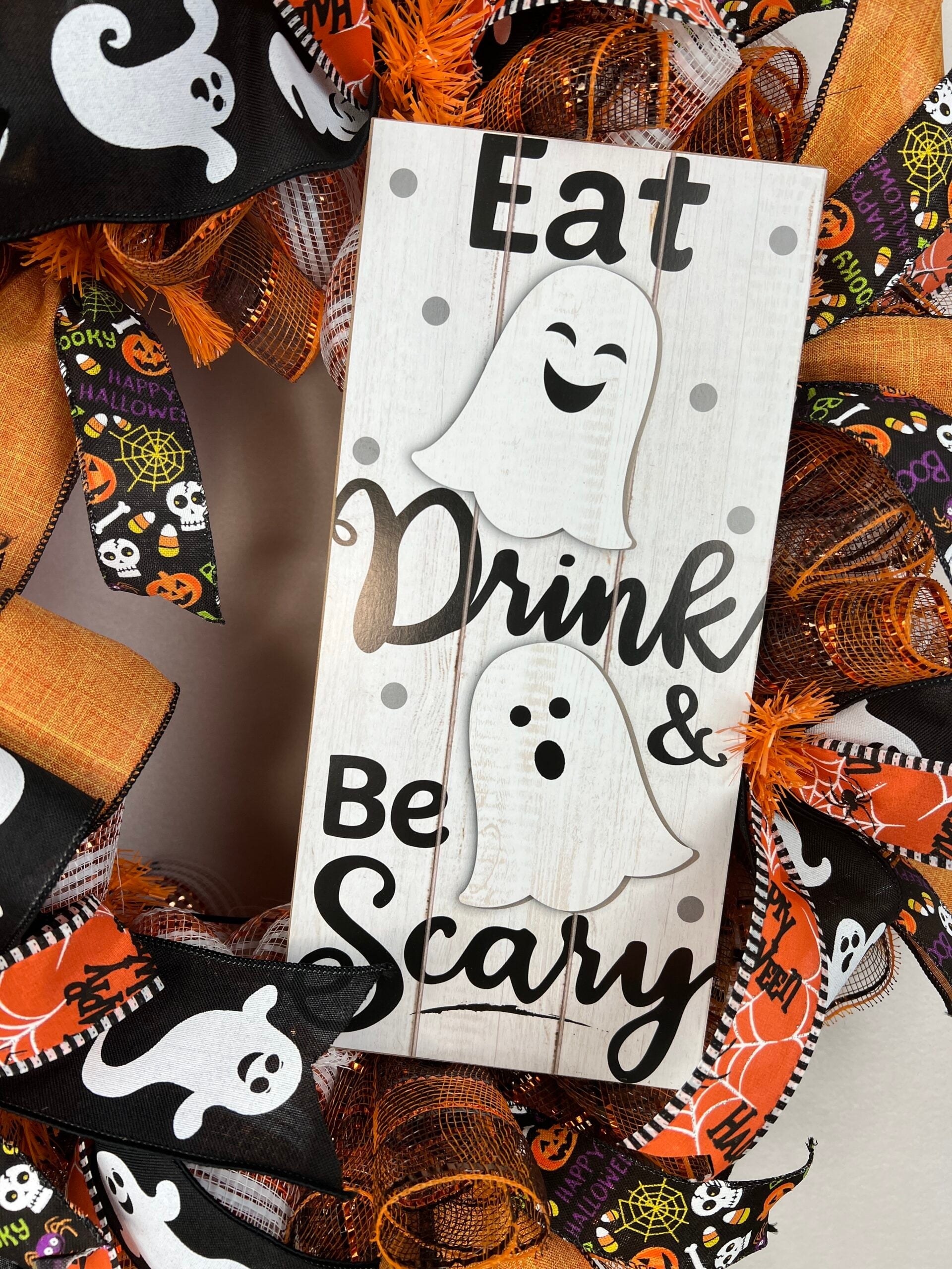 Halloween wreath with orange, black, ghost, and spider ribbon details
