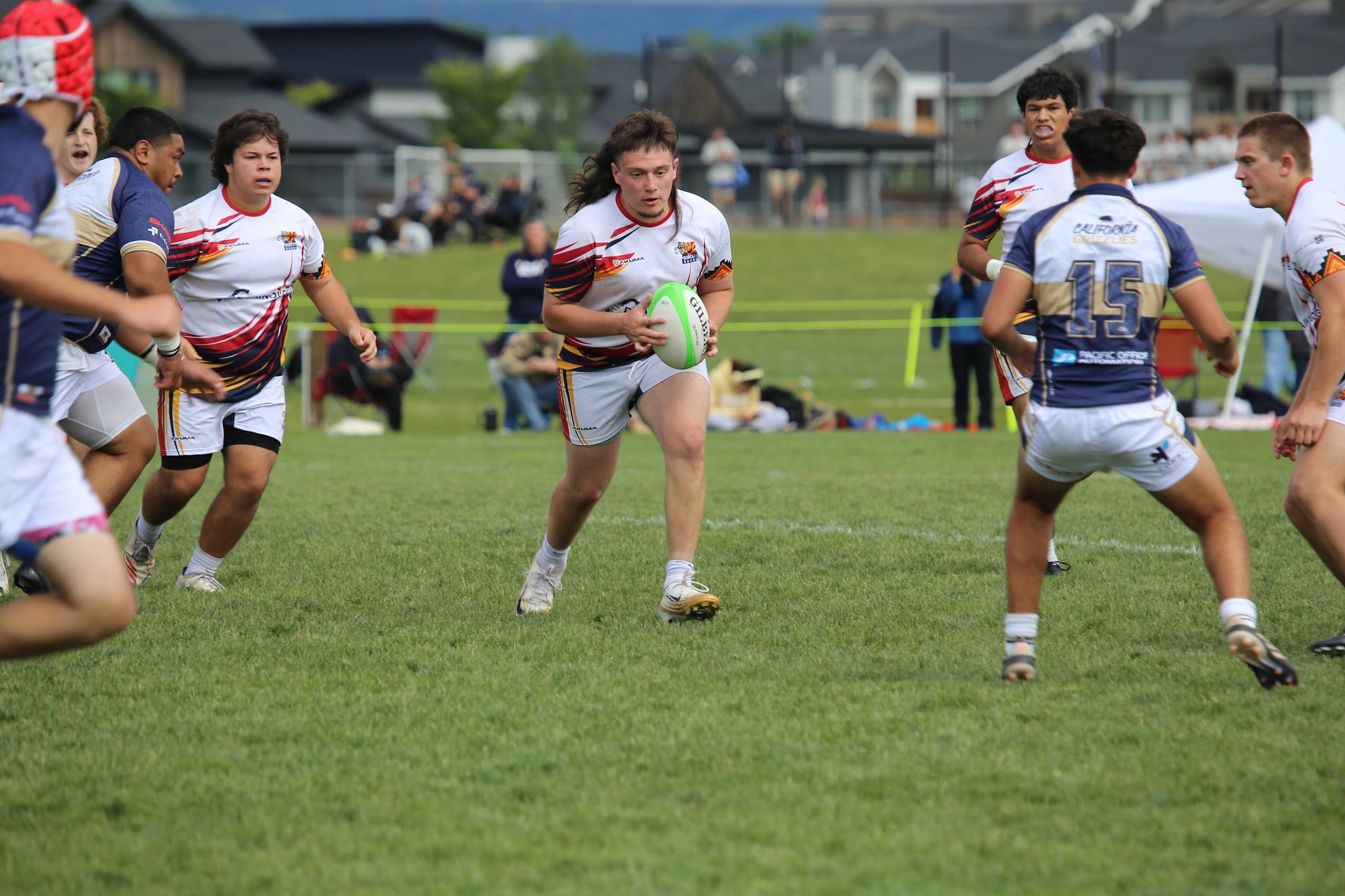 Bobcats rugby player carrying the ball toward the opposing defense