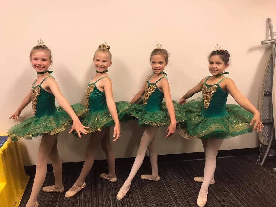Four DMSD ballet dancers in green and gold costumes