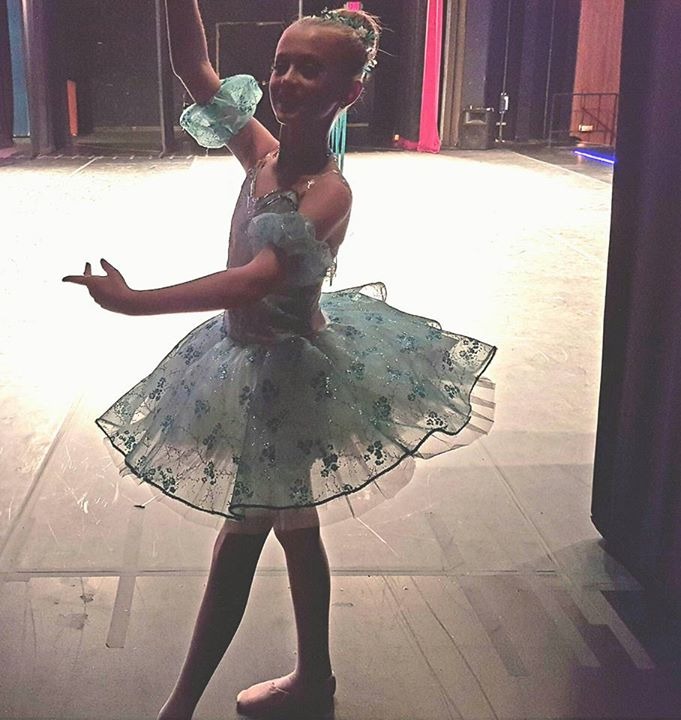 Young DMSD ballerina waiting backstage in her recital costume