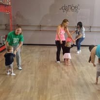 Young dancers learning with adults in the studio