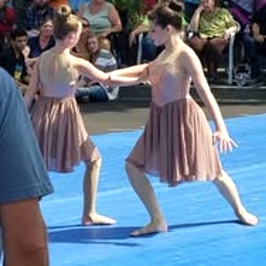 Senior lyrical dancers performing at a car show