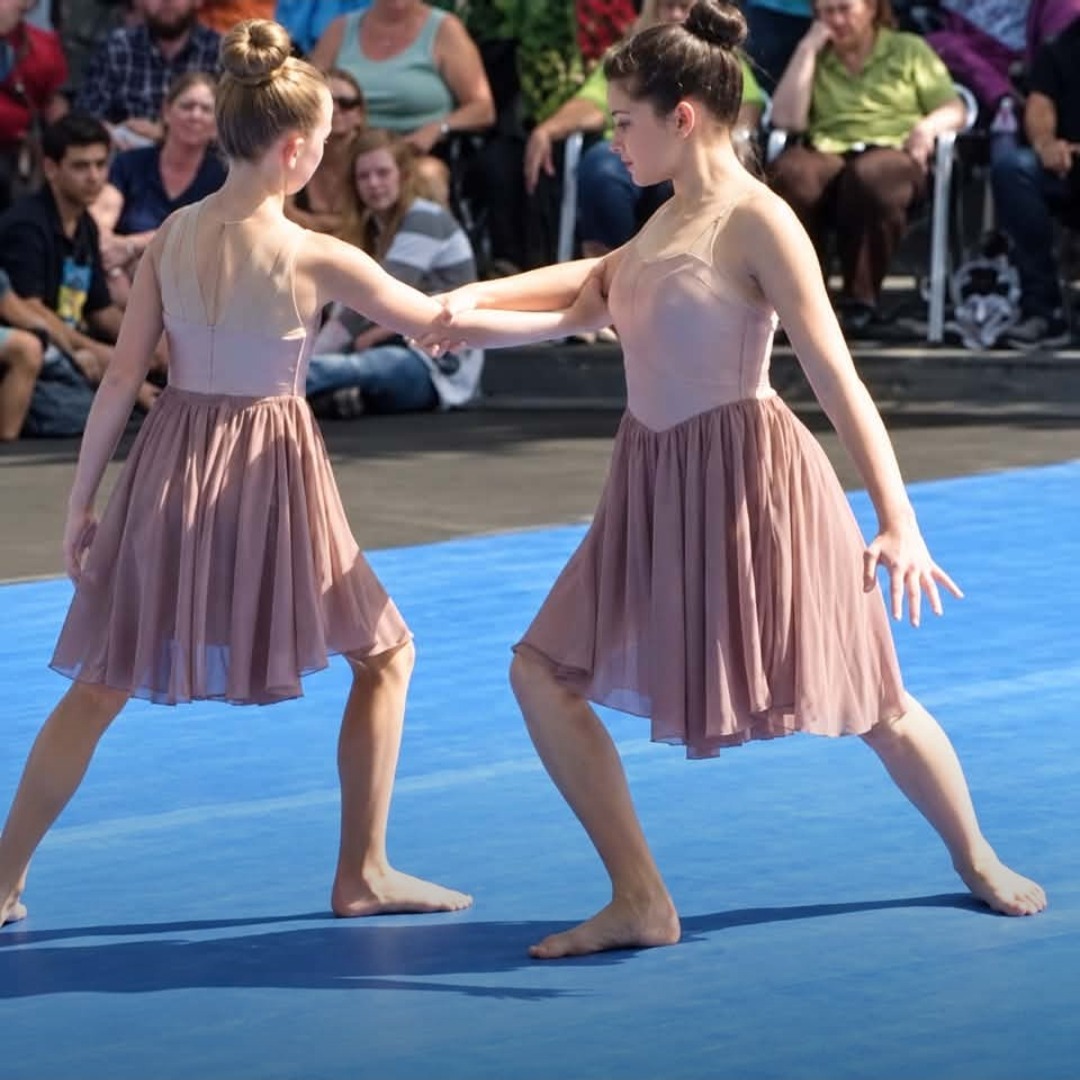 Senior lyrical dancers performing at a car show