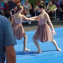 Senior lyrical dancers performing at a car show