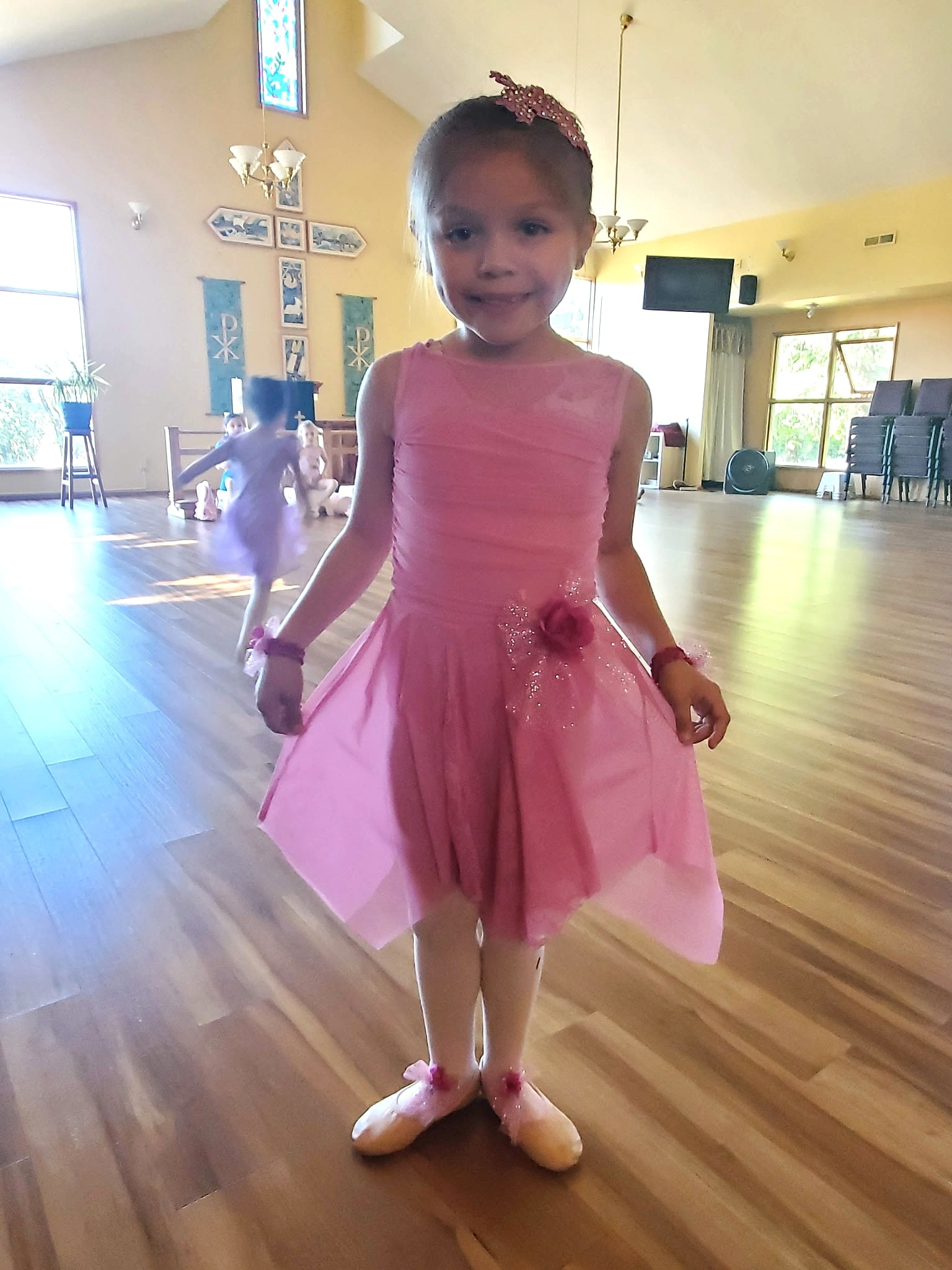 Young dancer in a pink dress at the studio