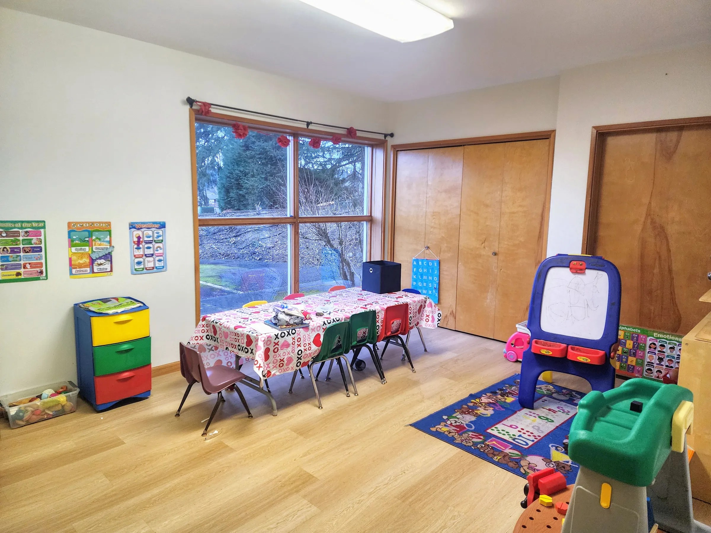 Inside Deborah’s Rising Stars Preschool classroom, with learning tables, colorful supplies, and play areas