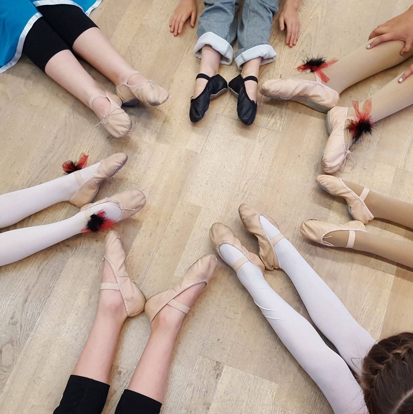 Young dancers’ ballet shoes in a circle