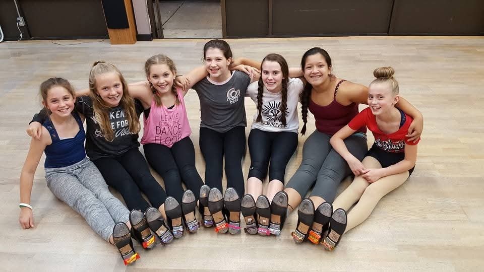 DMSD dancers sitting together in the studio
