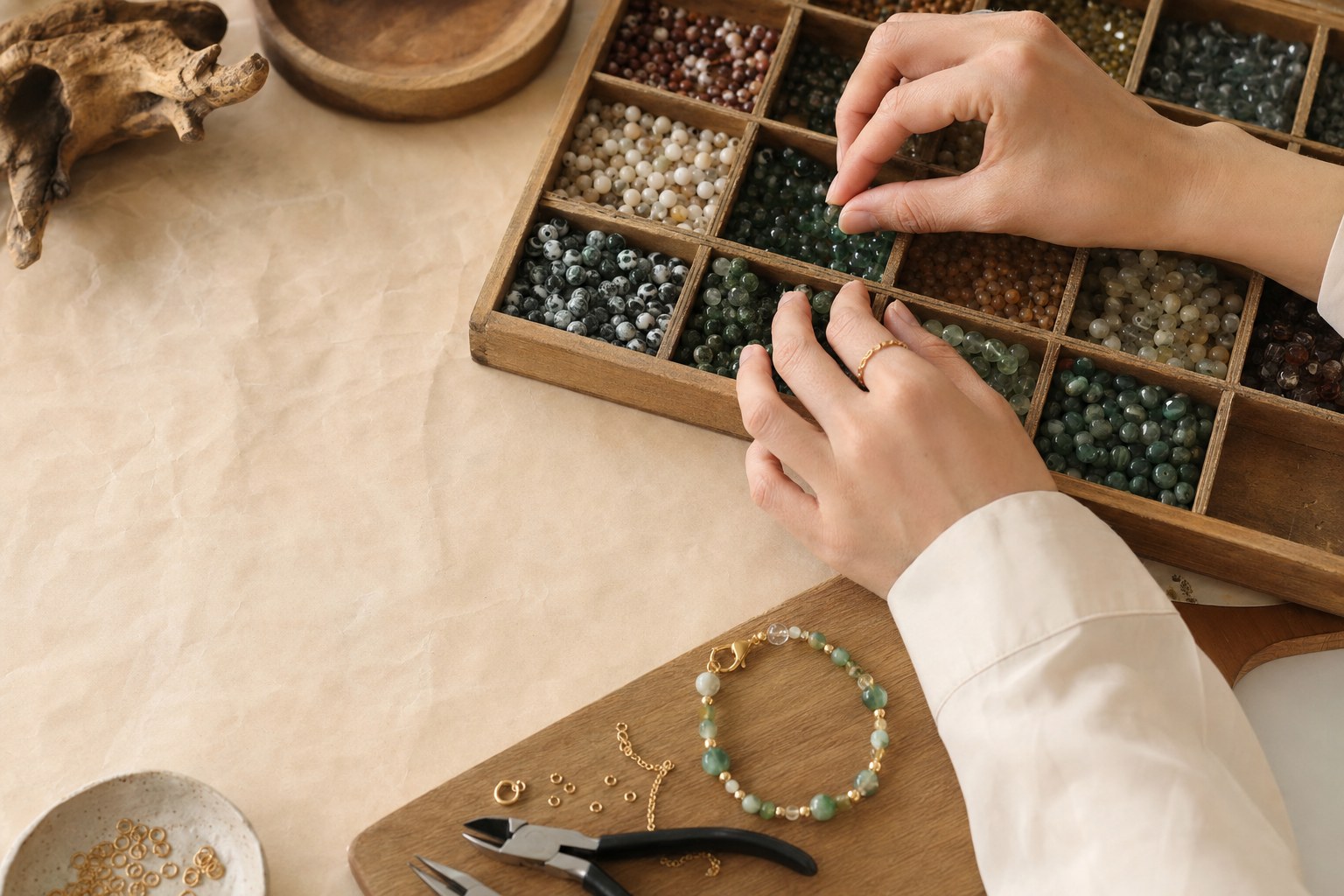 Jewelry maker selecting beads from organized trays