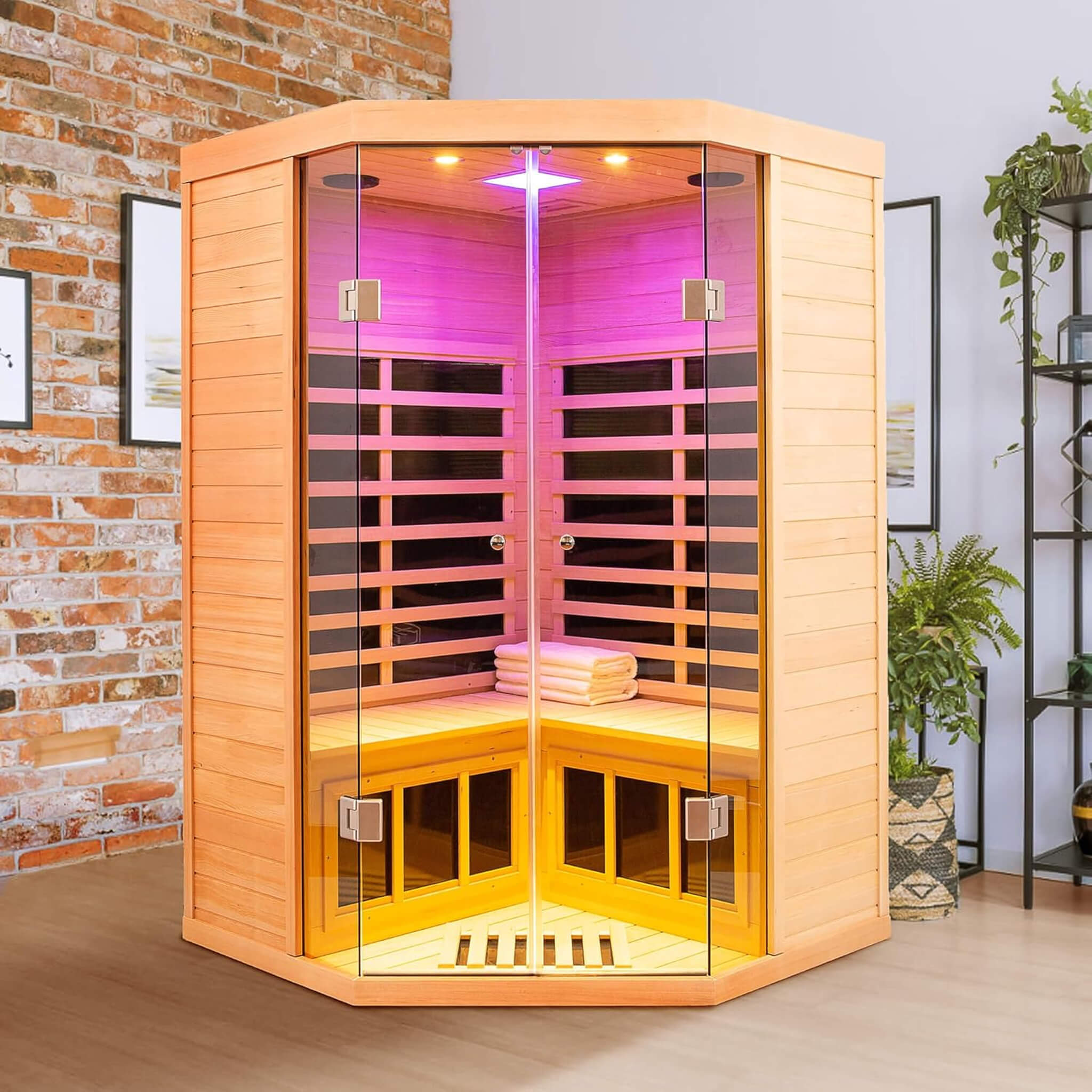 An indoor corner sauna with clear space in front of its glass door
