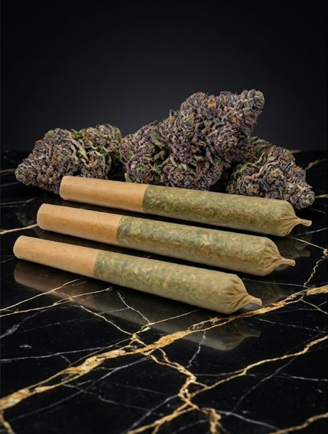 Stoned Ponies pre-rolls displayed with flower on a dark surface
