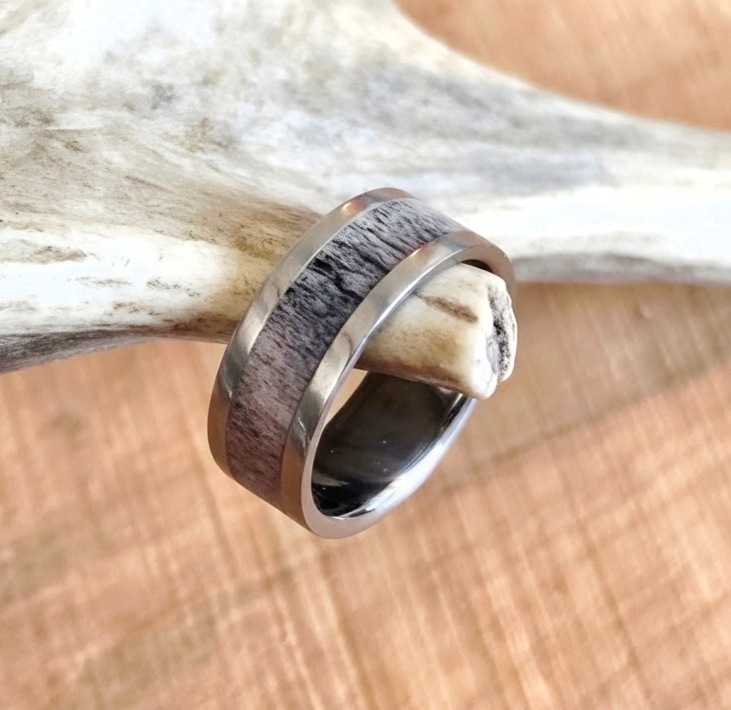 Handmade antler inlay ring on a natural antler