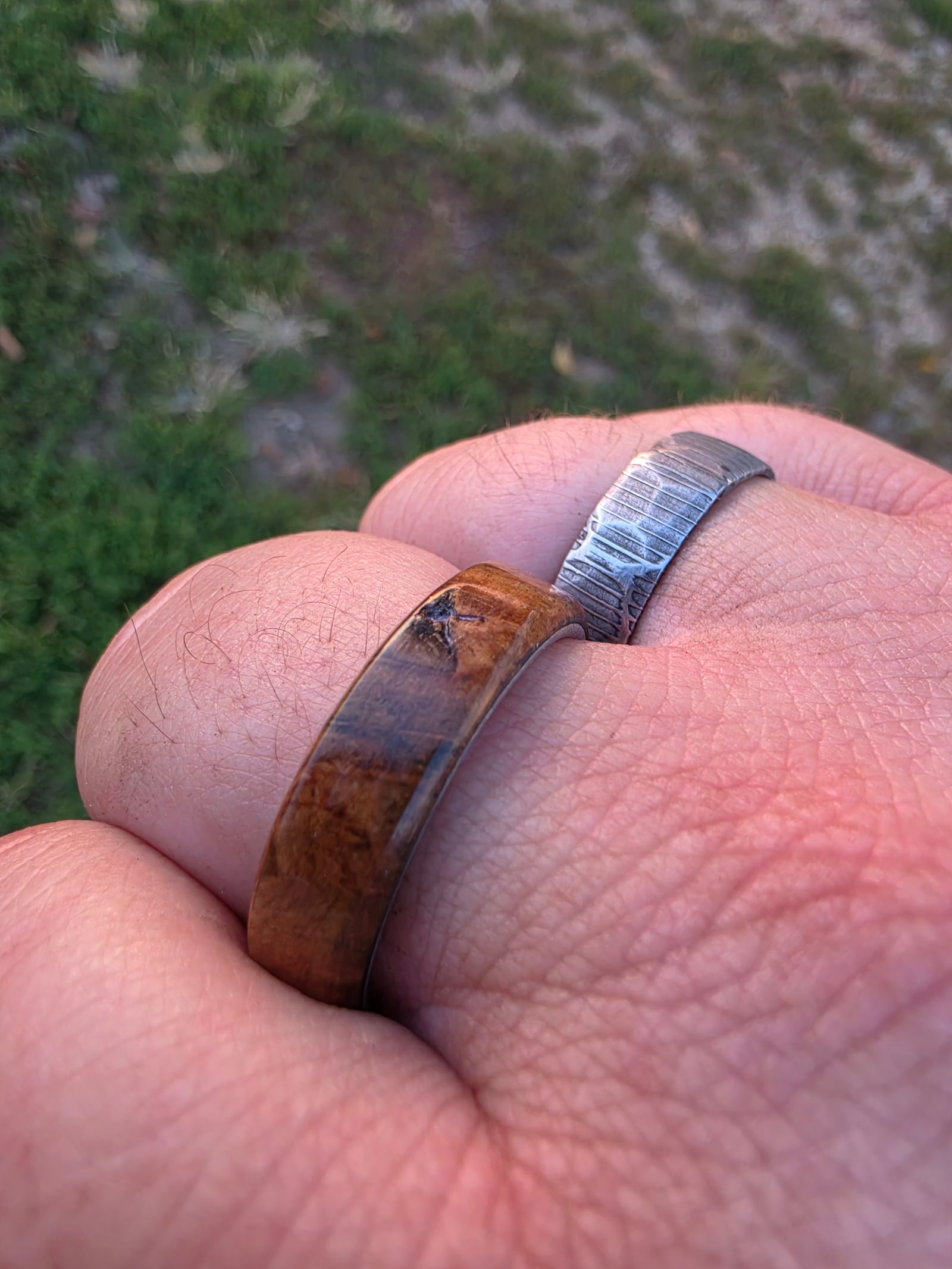 Finished handmade rings on a wearer’s hand