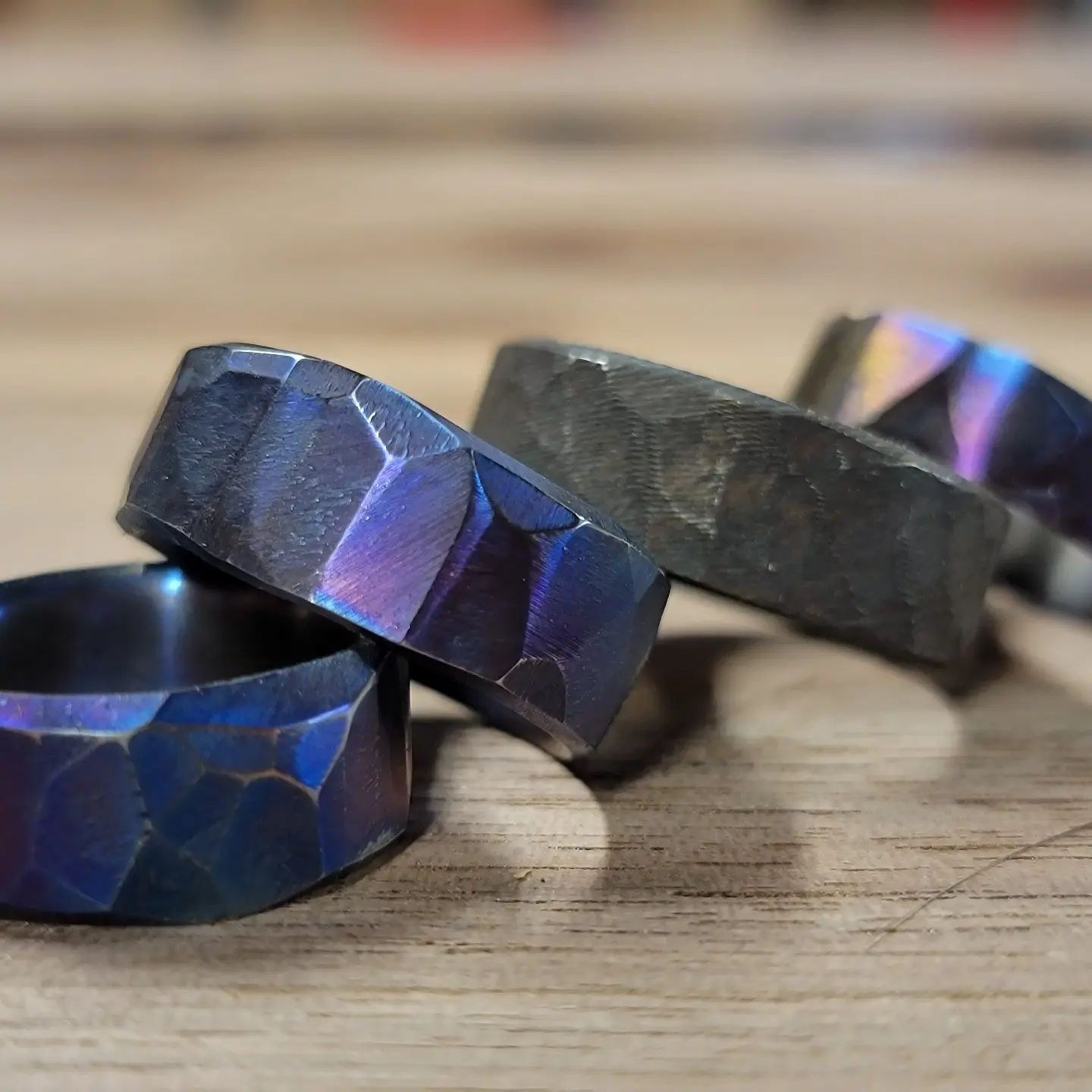 Dark flame-anodized titanium ring with a textured obsidian finish