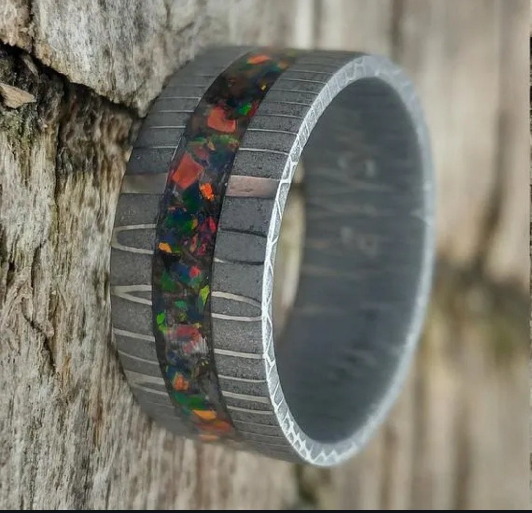 Close view of a stainless Damascus ring with a circular patterned surface