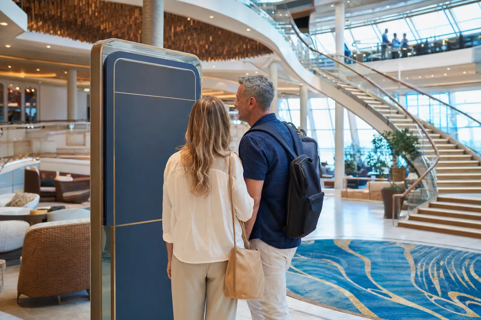 Two travelers reading a ship directory in a bright cruise ship atrium before exploring the onboard spaces.