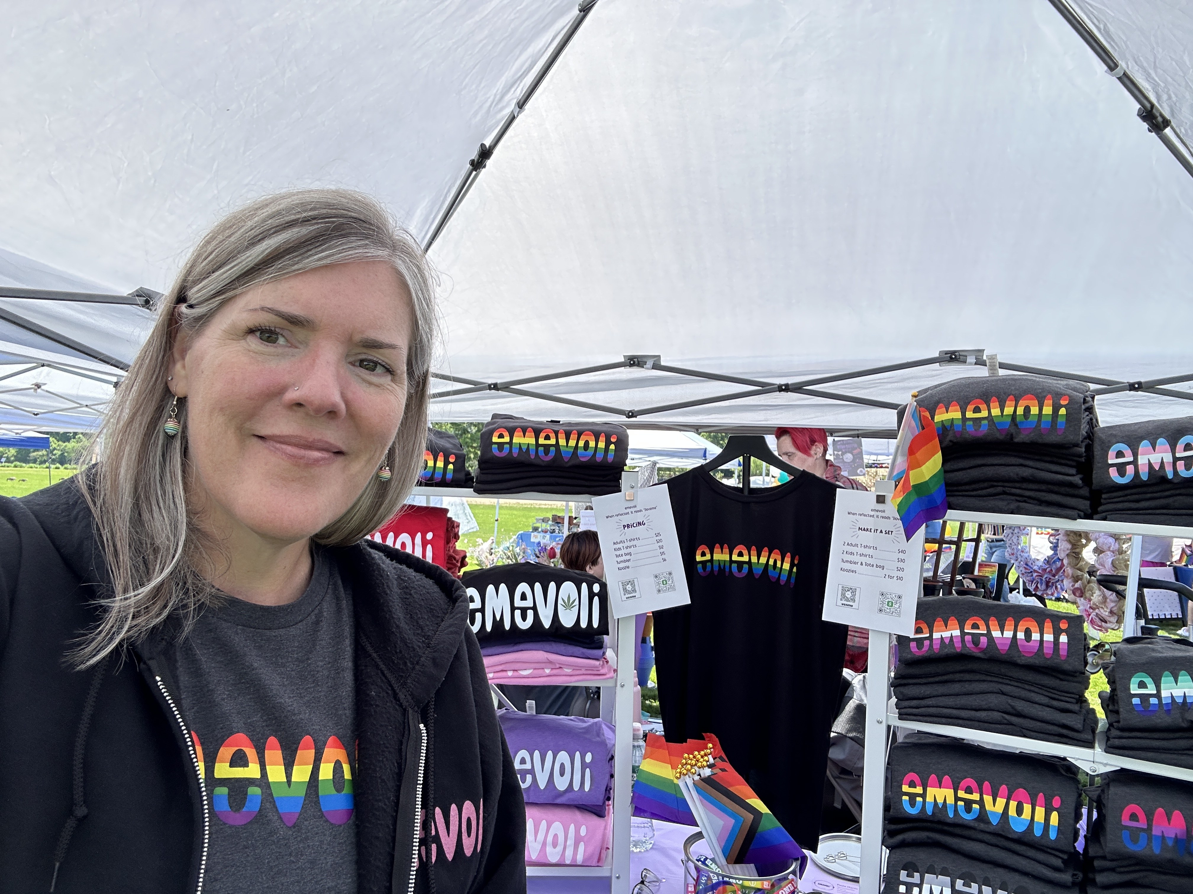 Paula standing with emevoli apparel and gifts at an outdoor market
