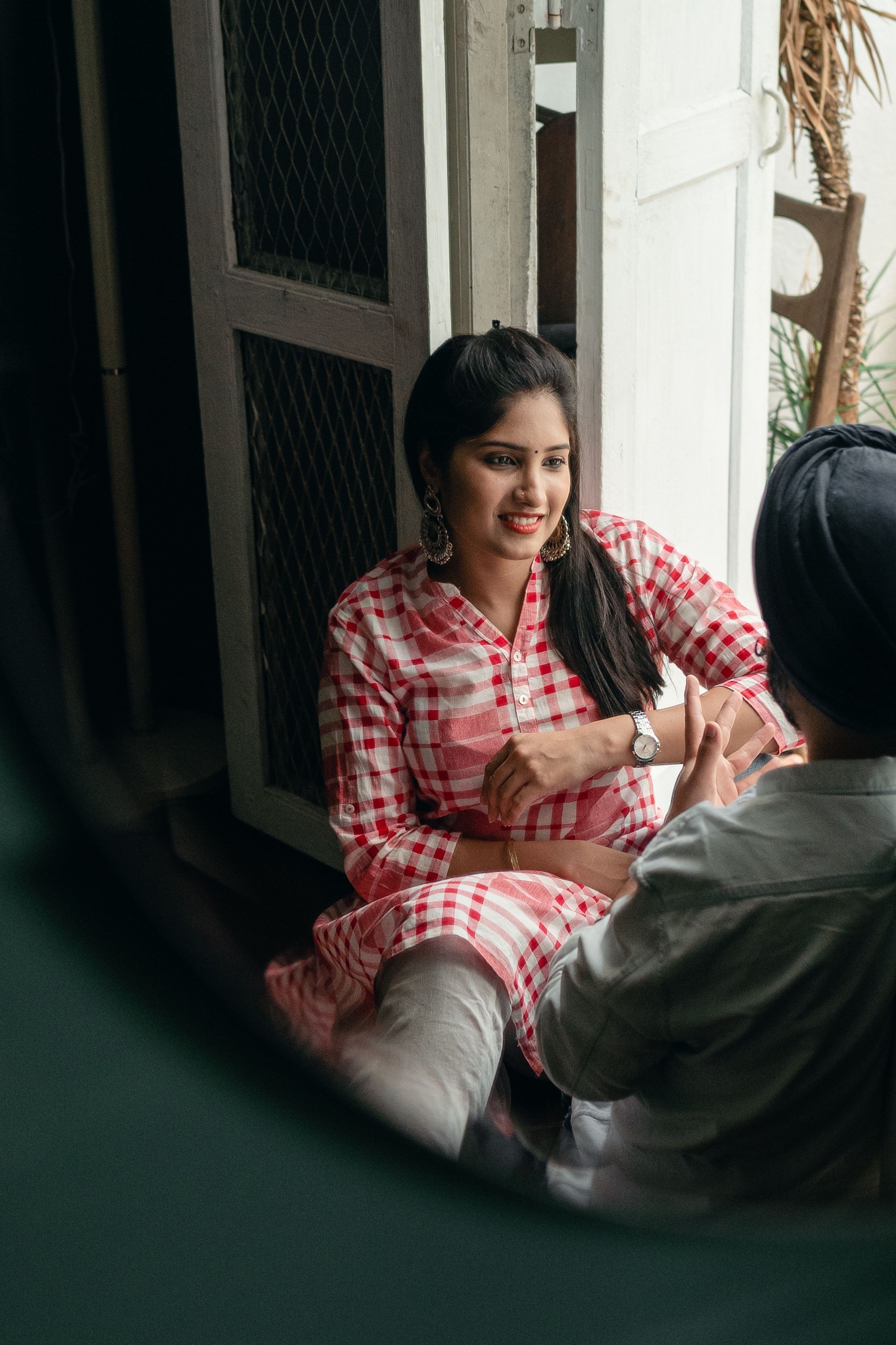 Two people talking together in a home.