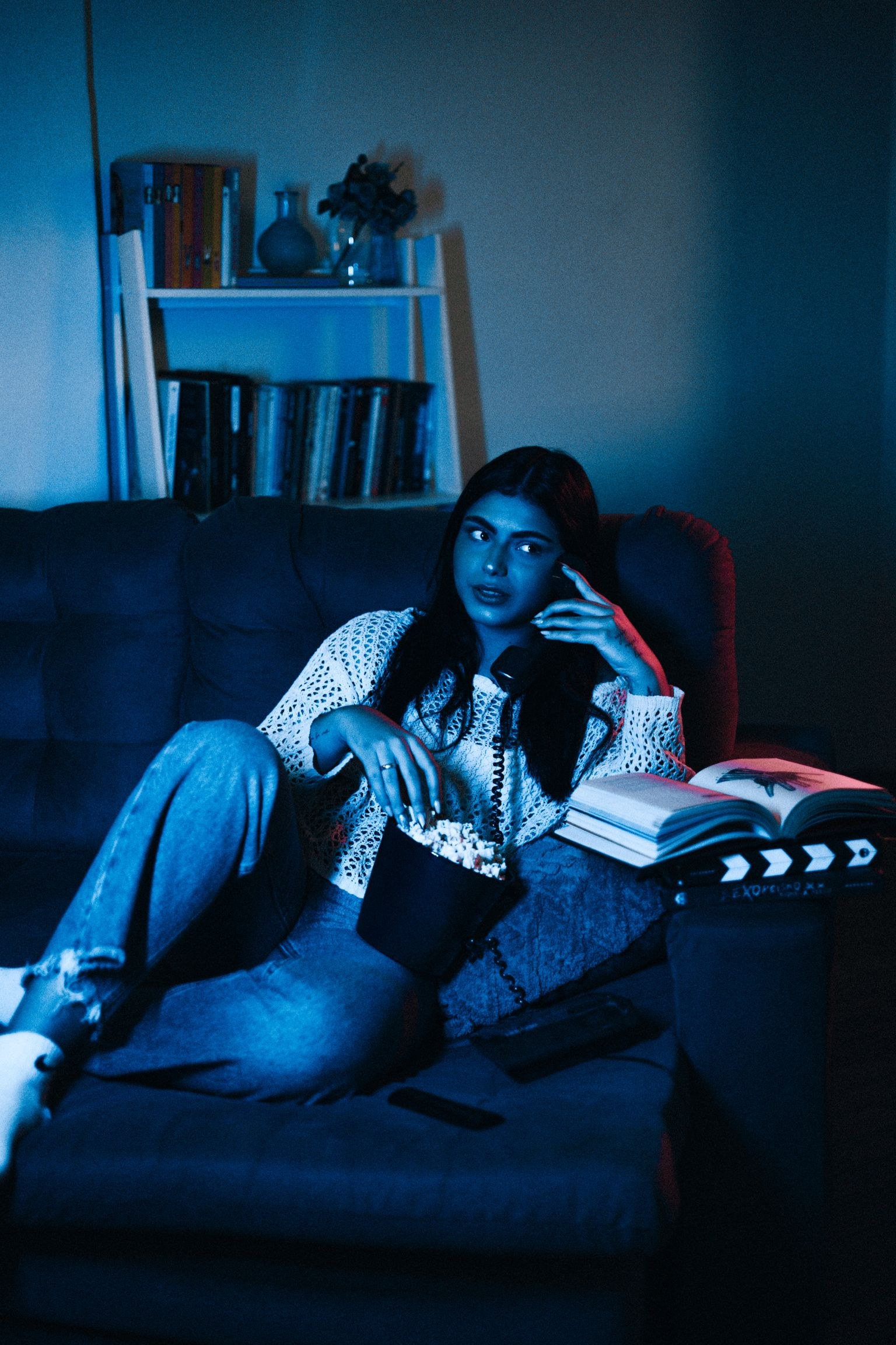 A woman watching a movie at home.