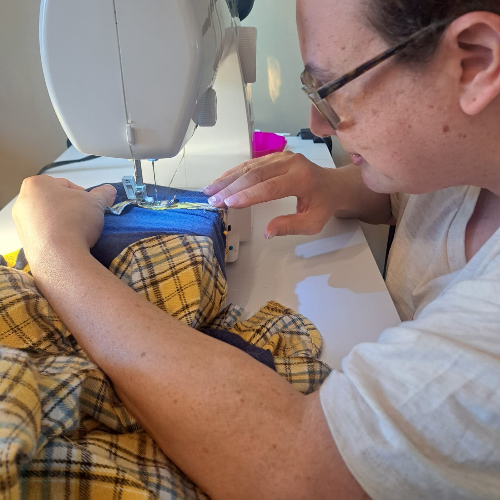 Working at the sewing machine at PYAJ Sewing Studio