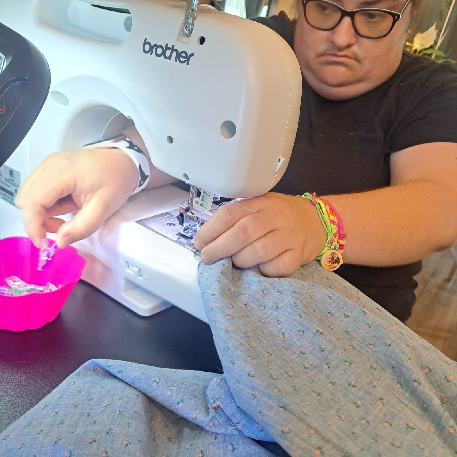 Guiding fabric through the machine at PYAJ Sewing Studio