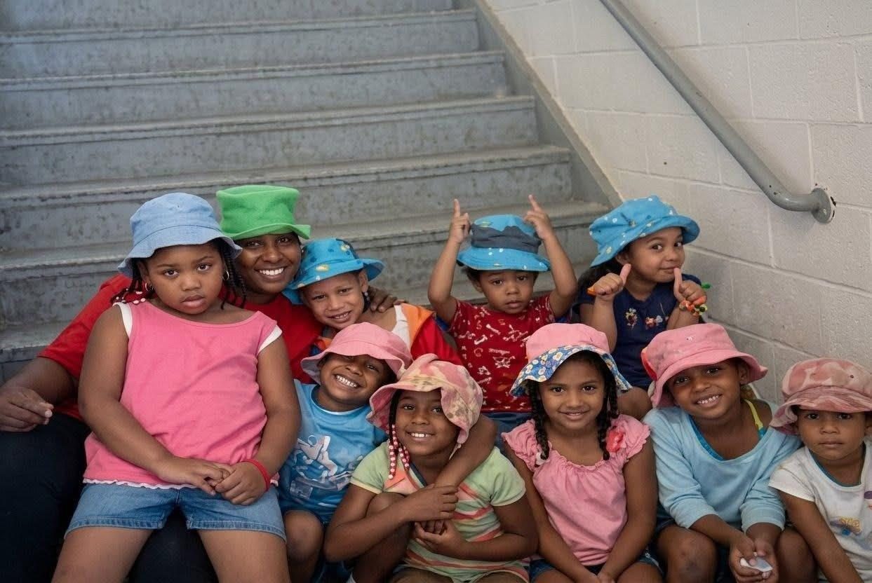 A group in colorful hats at PYAJ Sewing Studio