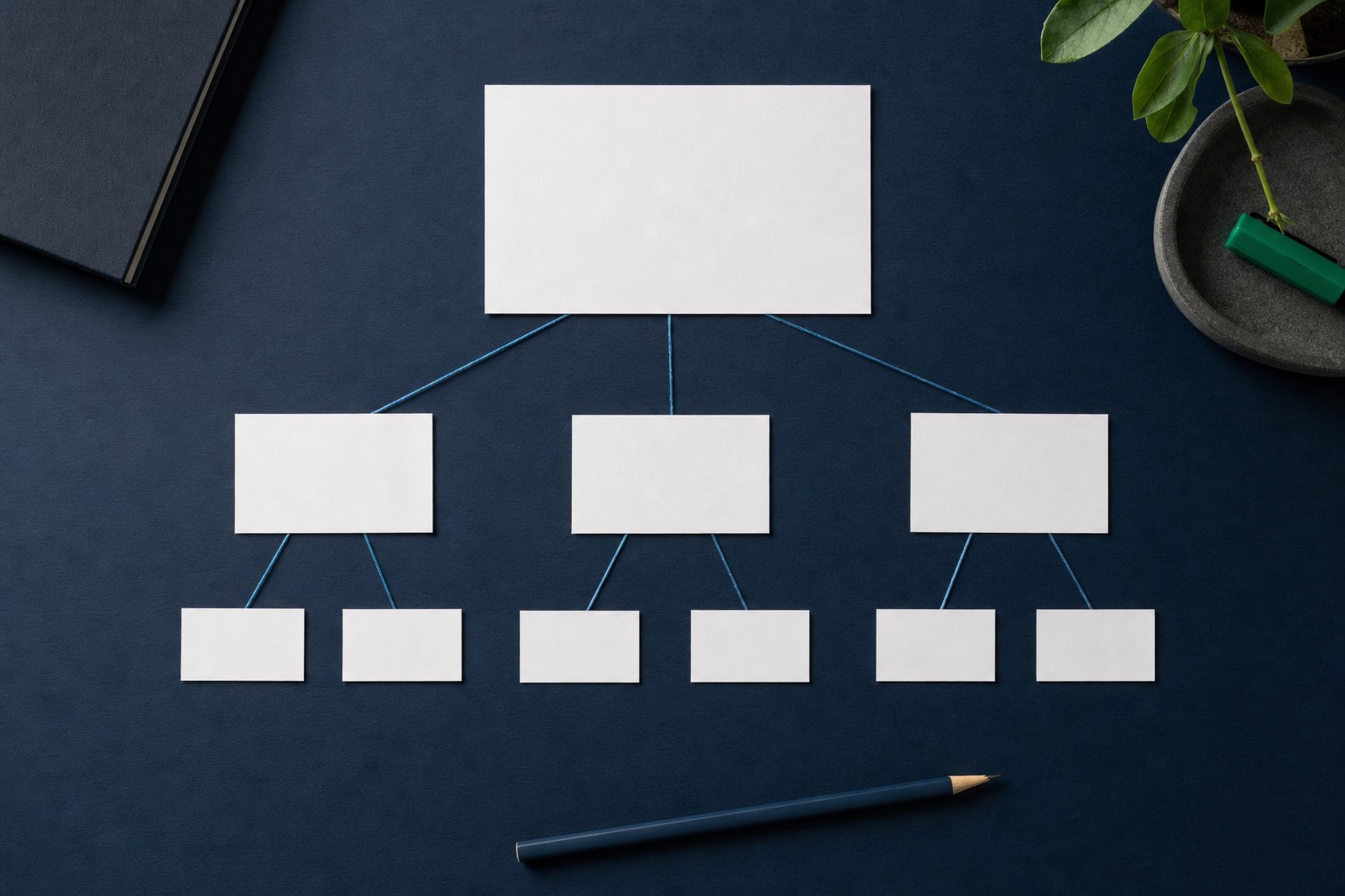 Blank metric cards connected in a hierarchy on a navy work surface