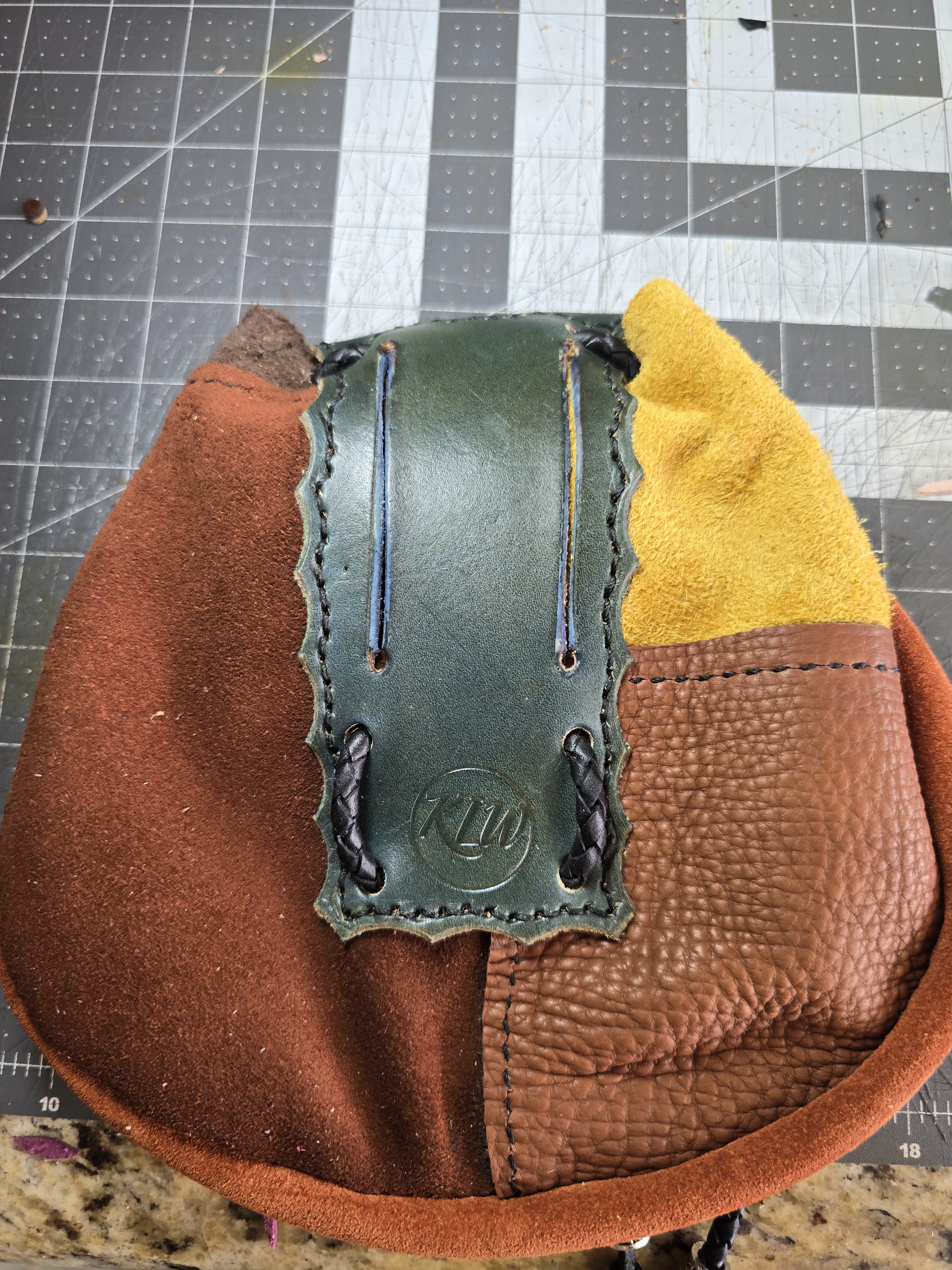 Back of the Fae-Stitch Satchel showing its belt loops and patchwork leather