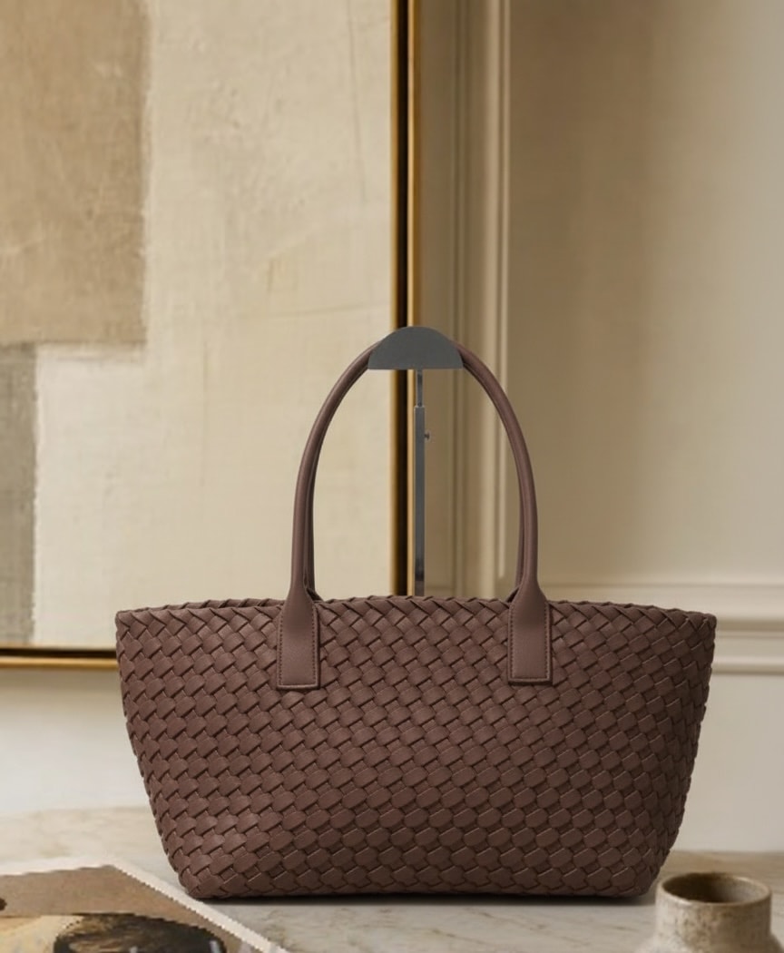 Textured black handbag with refined woven leather detail