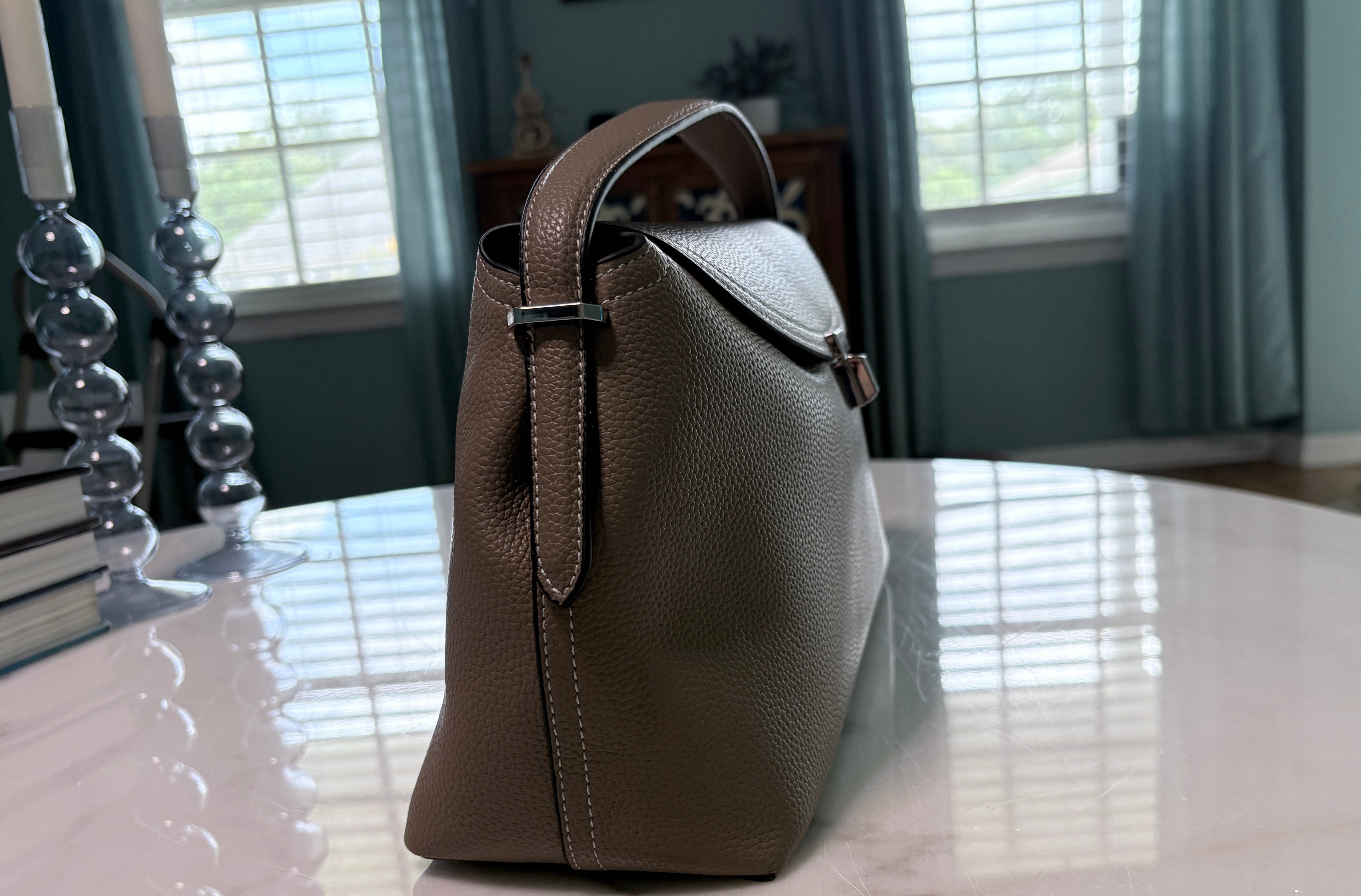 Taupe leather satchel with silver-toned closure and detachable strap