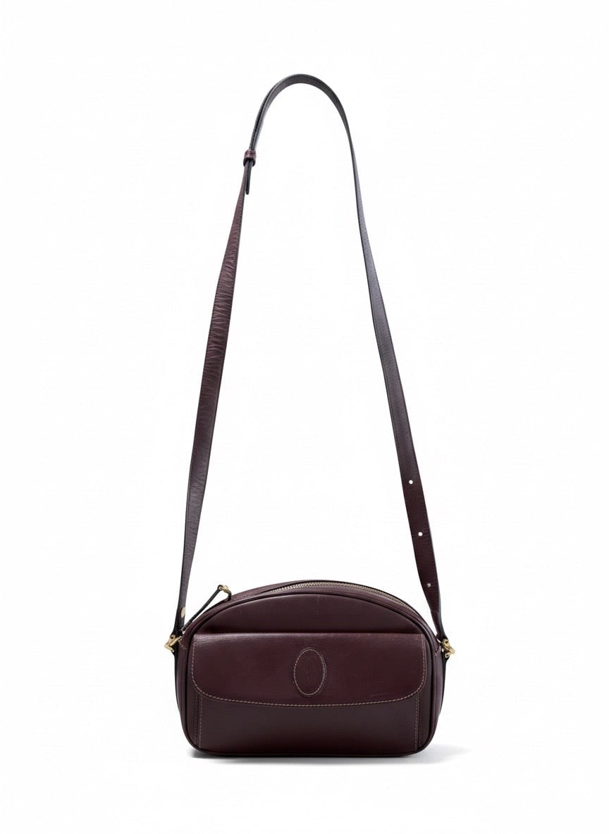 Vintage burgundy leather handbag with gold-toned hardware