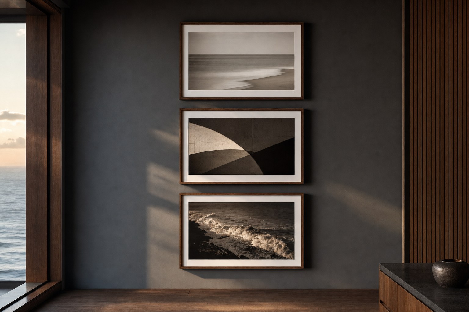 Three framed photographic artworks arranged on a charcoal wall in a modern room.