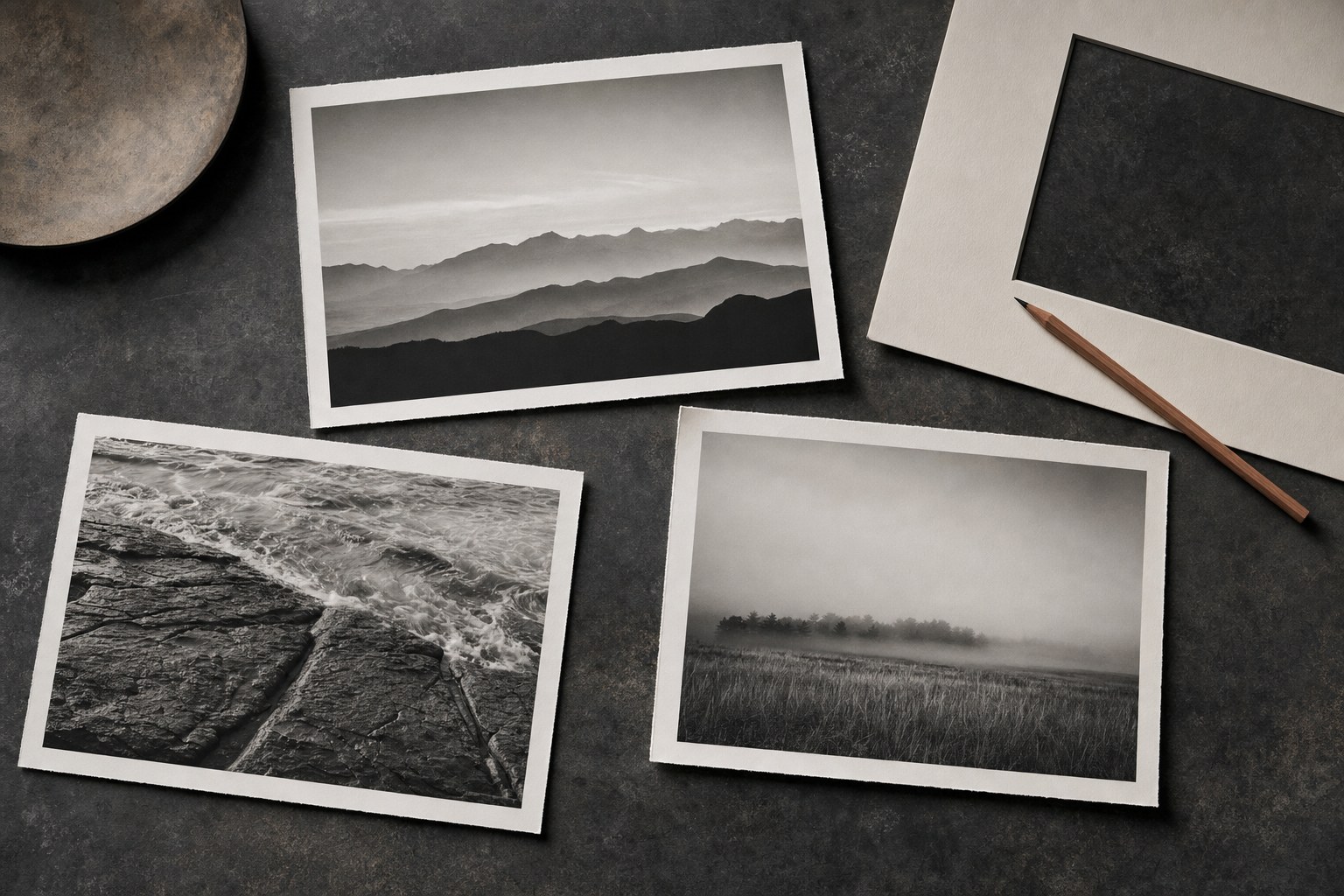 Three landscape photography print proofs arranged beside a mat board and pencil.