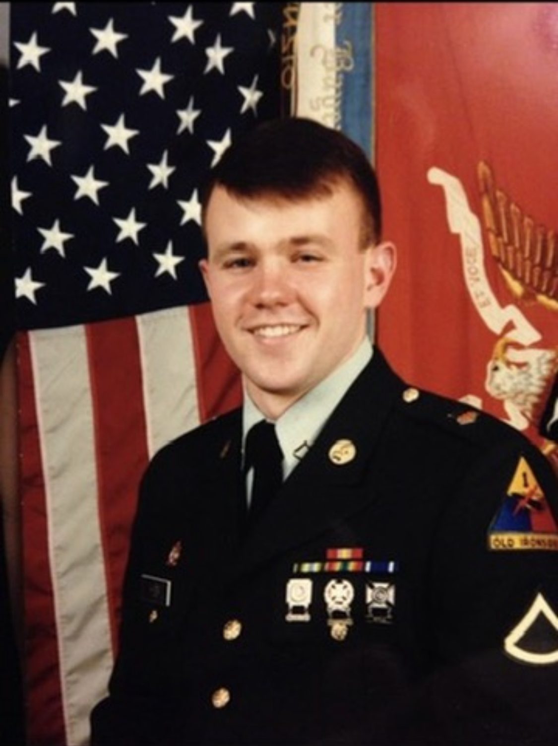 Army dress-uniform portrait in front of the American flag