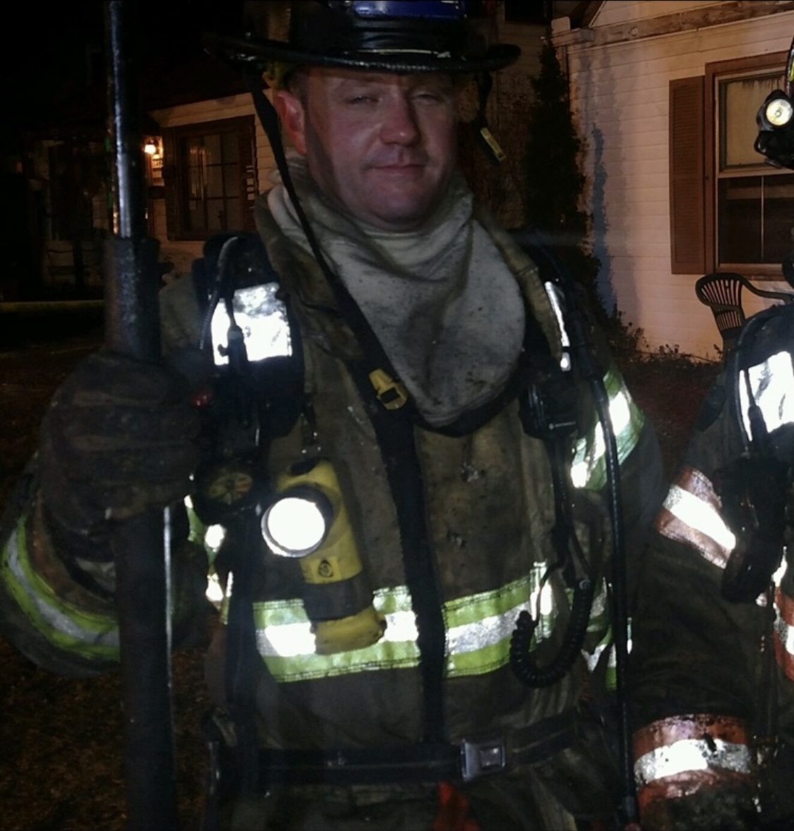 Firefighter wearing a helmet and full protective gear