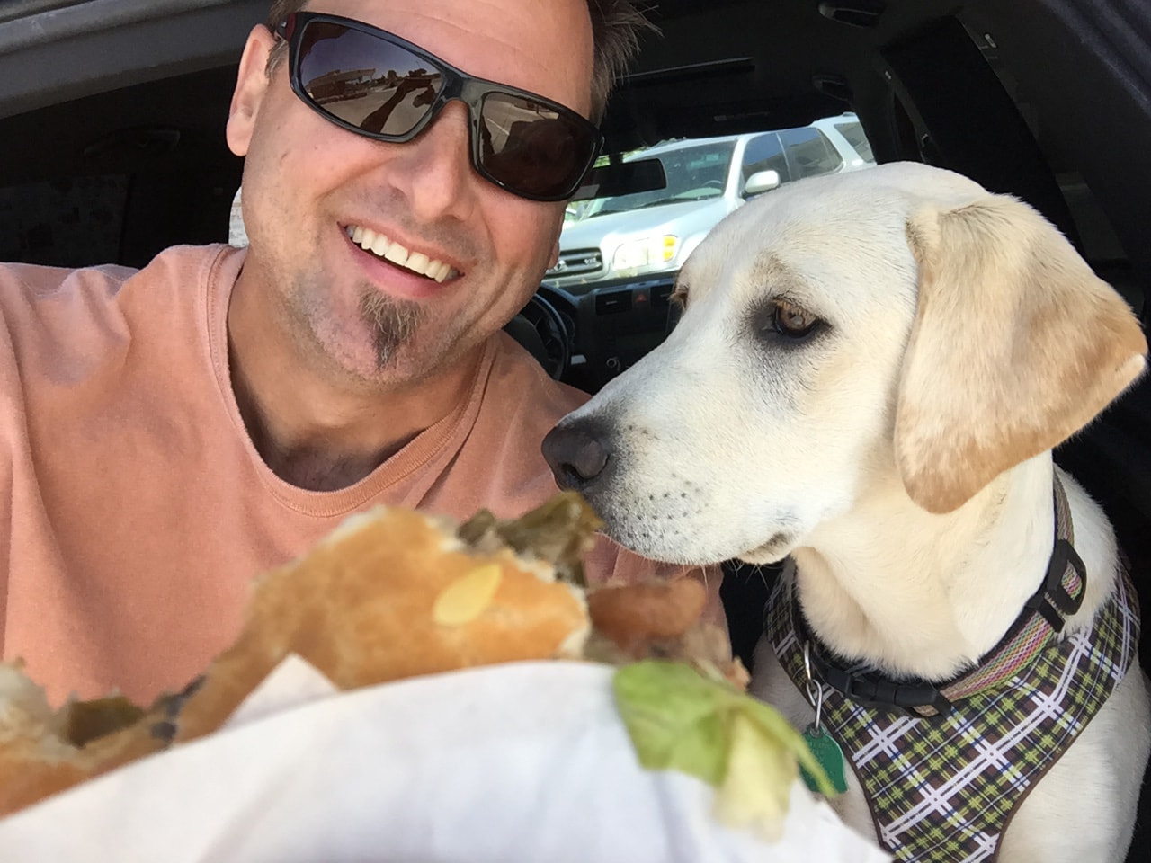 Hunter Hampton with his dog Darby and a cheeseburger