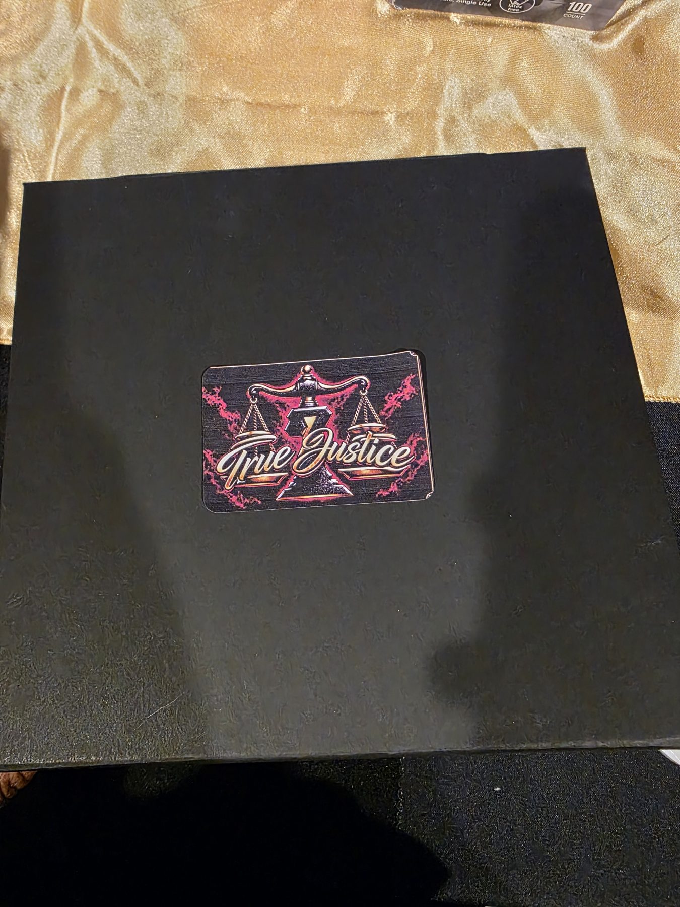 Closed black custom gift box featuring the customer’s True Justice company logo