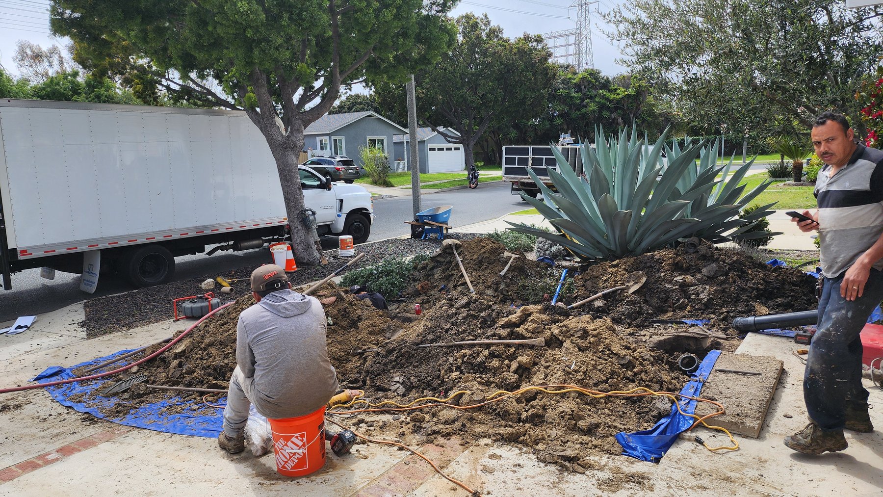 Excavation work exposing underground piping at a property