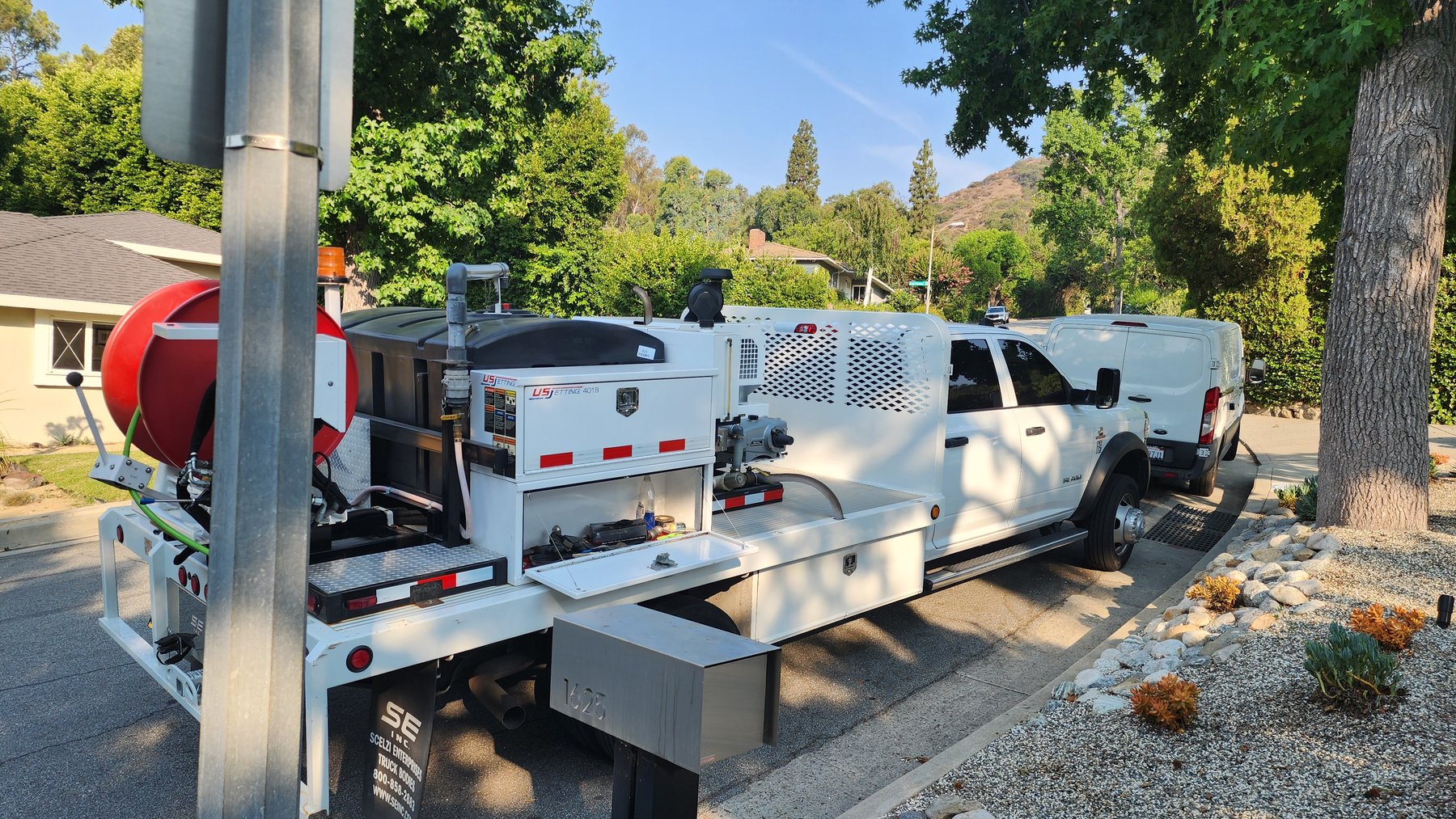 Anytime Rooter service truck and equipment at a residential jobsite