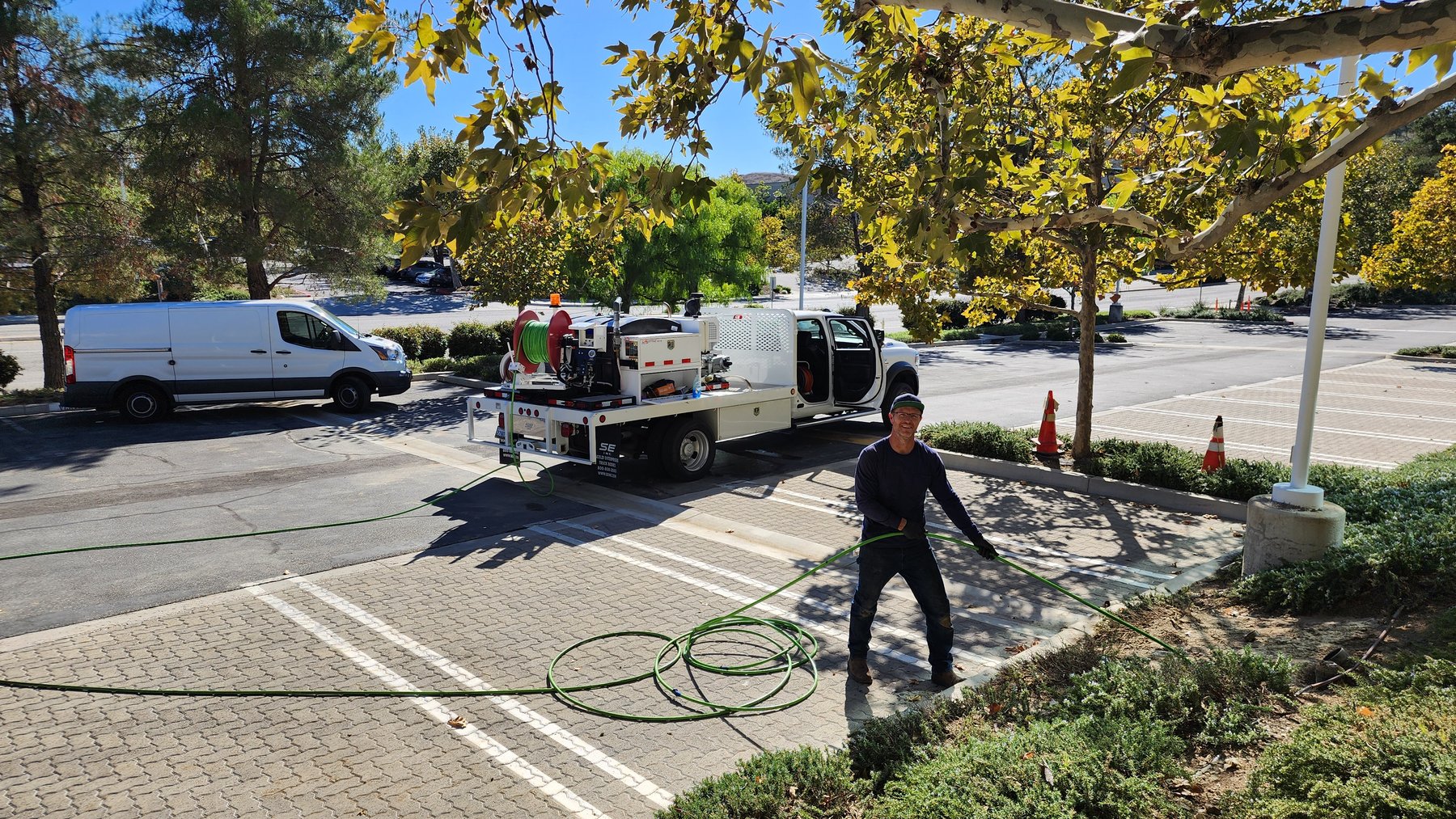 Hydro jetting equipment operating beside a service truck