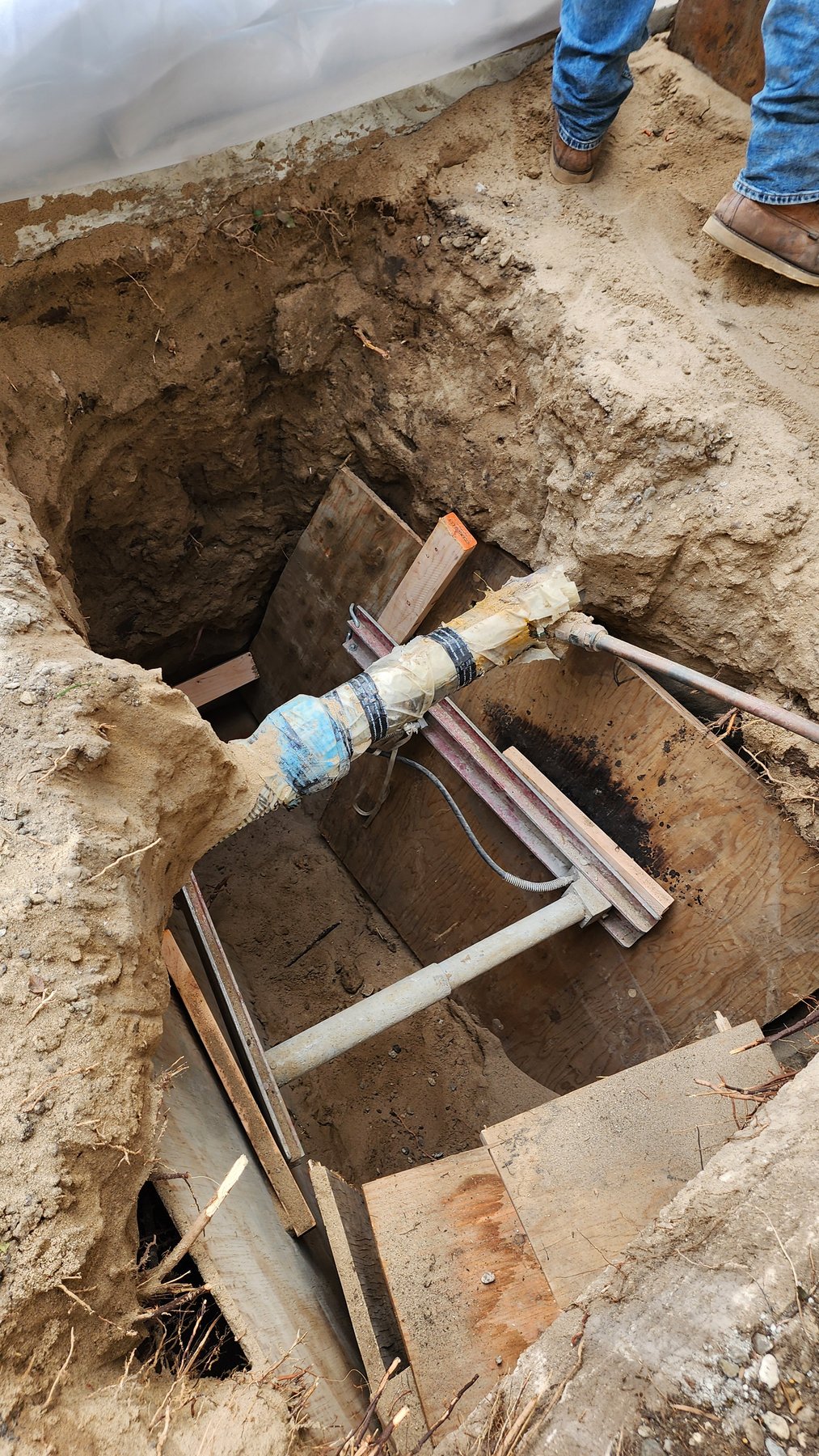 Underground sewer piping exposed for repair work