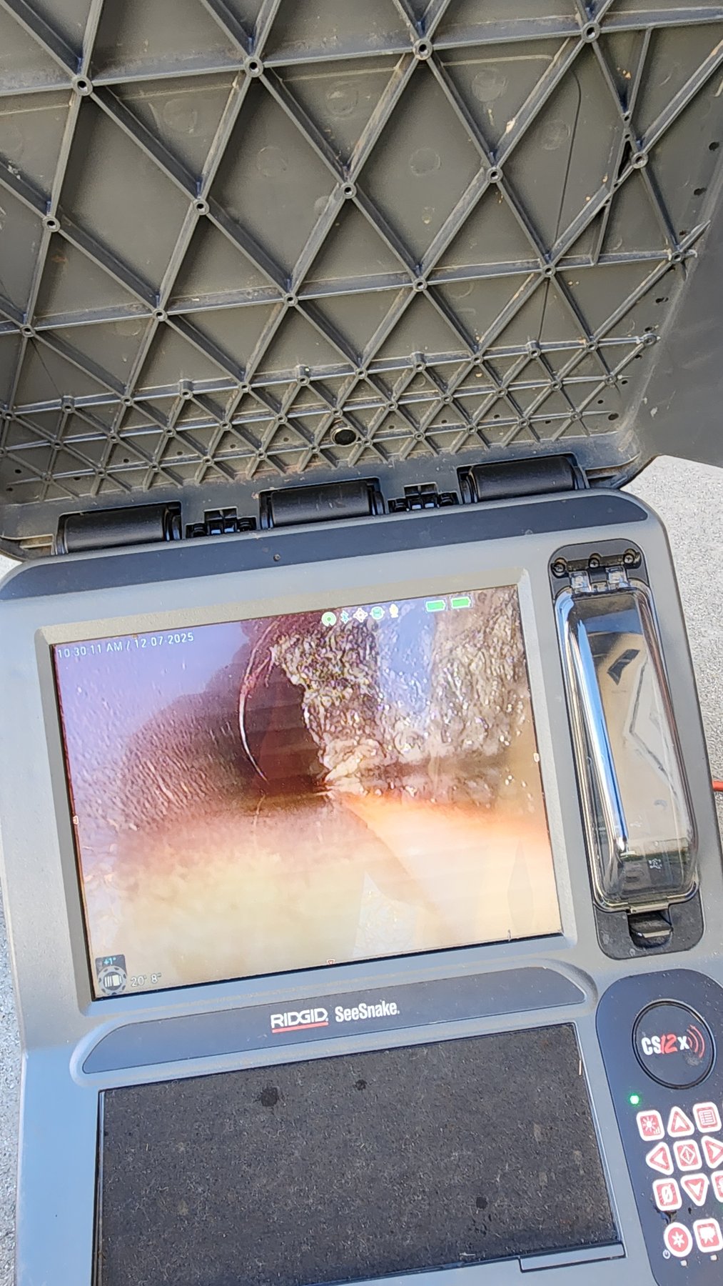 Sewer camera monitor showing pipe conditions