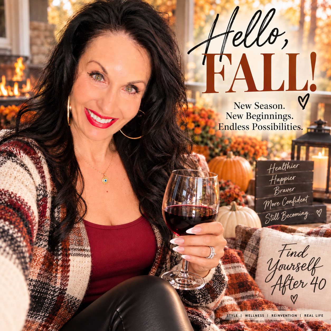 Stacey Creely holding a glass of red wine in a cozy fall setting with pumpkins and autumn flowers.